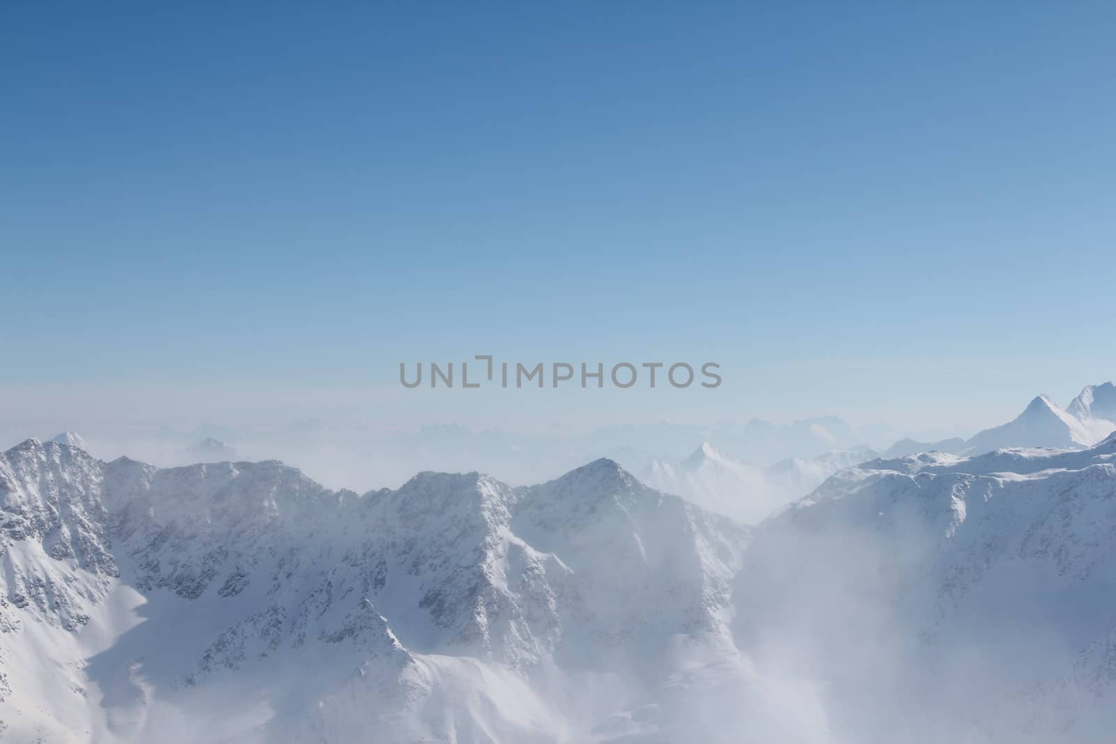 Range of winter mountain peaks at sunny day at Soelden Austria