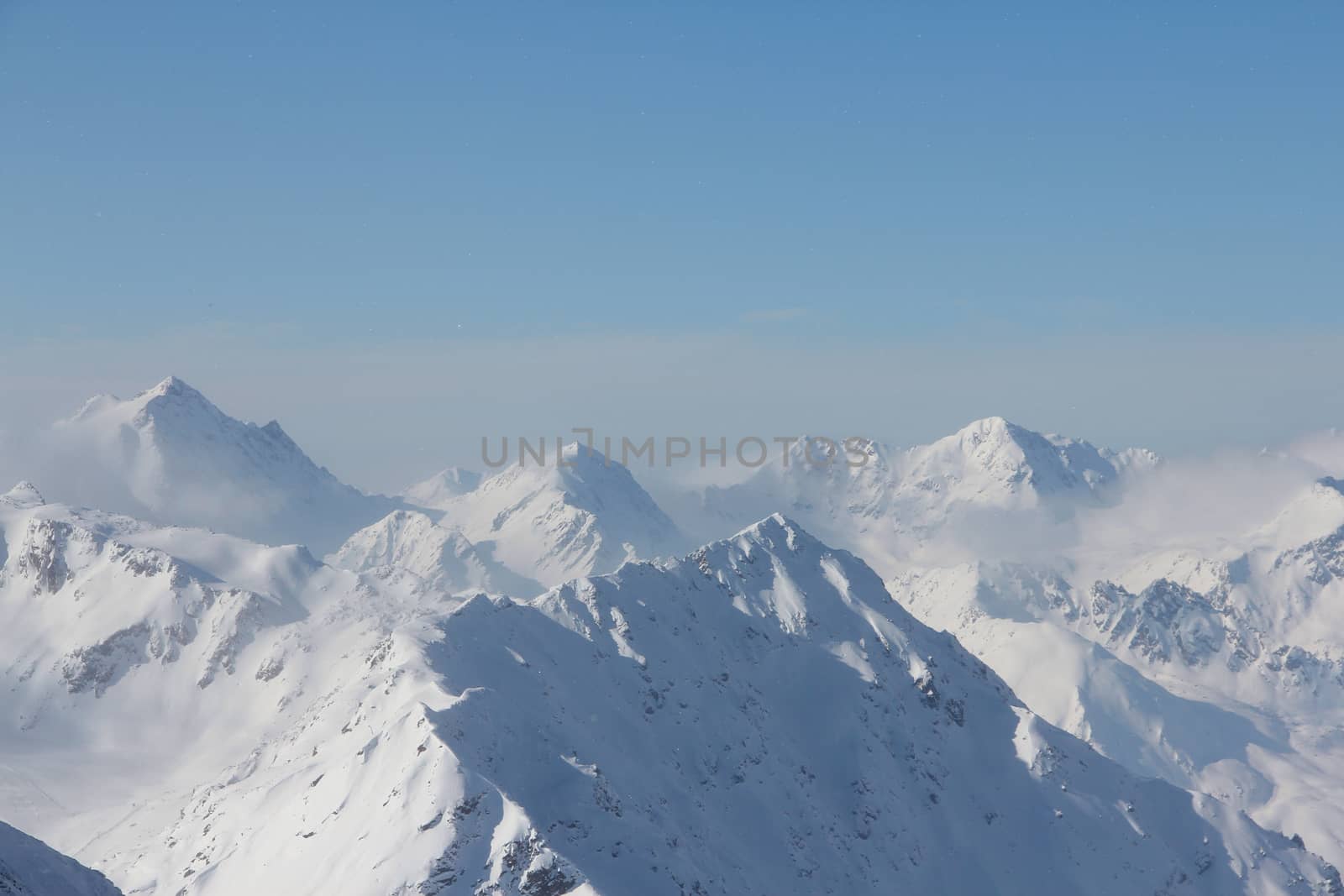 Range of winter mountain peaks at sunny day at Soelden Austria