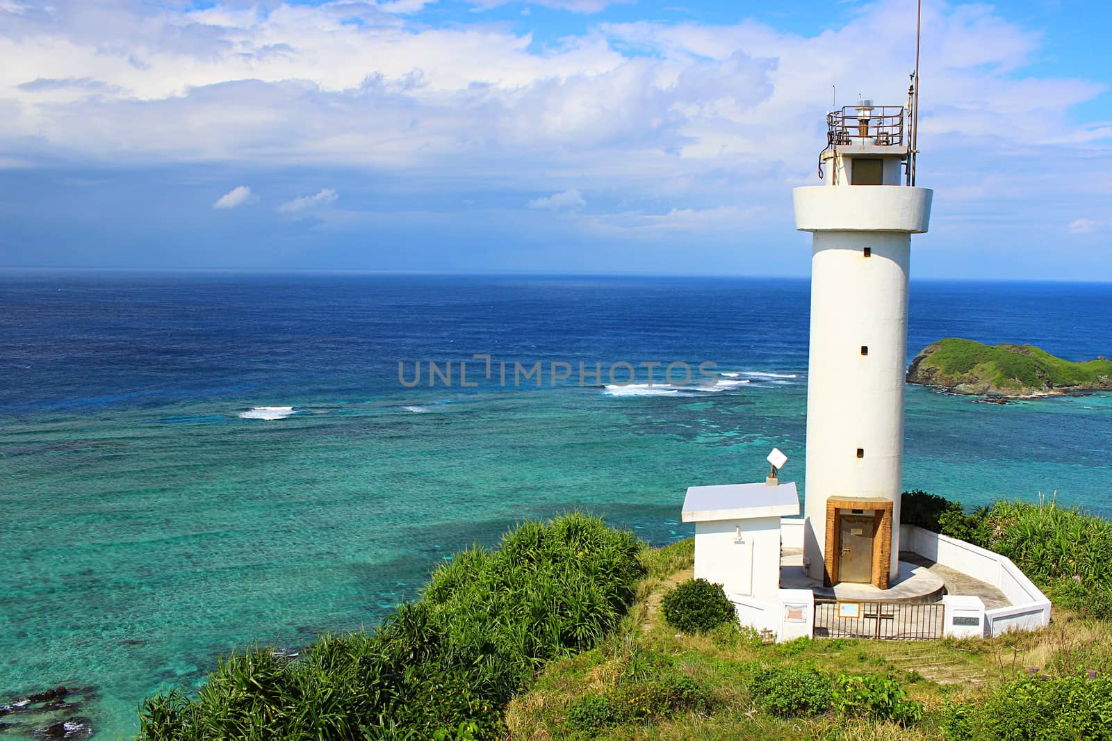 View of the ocean and lighthouse with beautiful blue/green water.