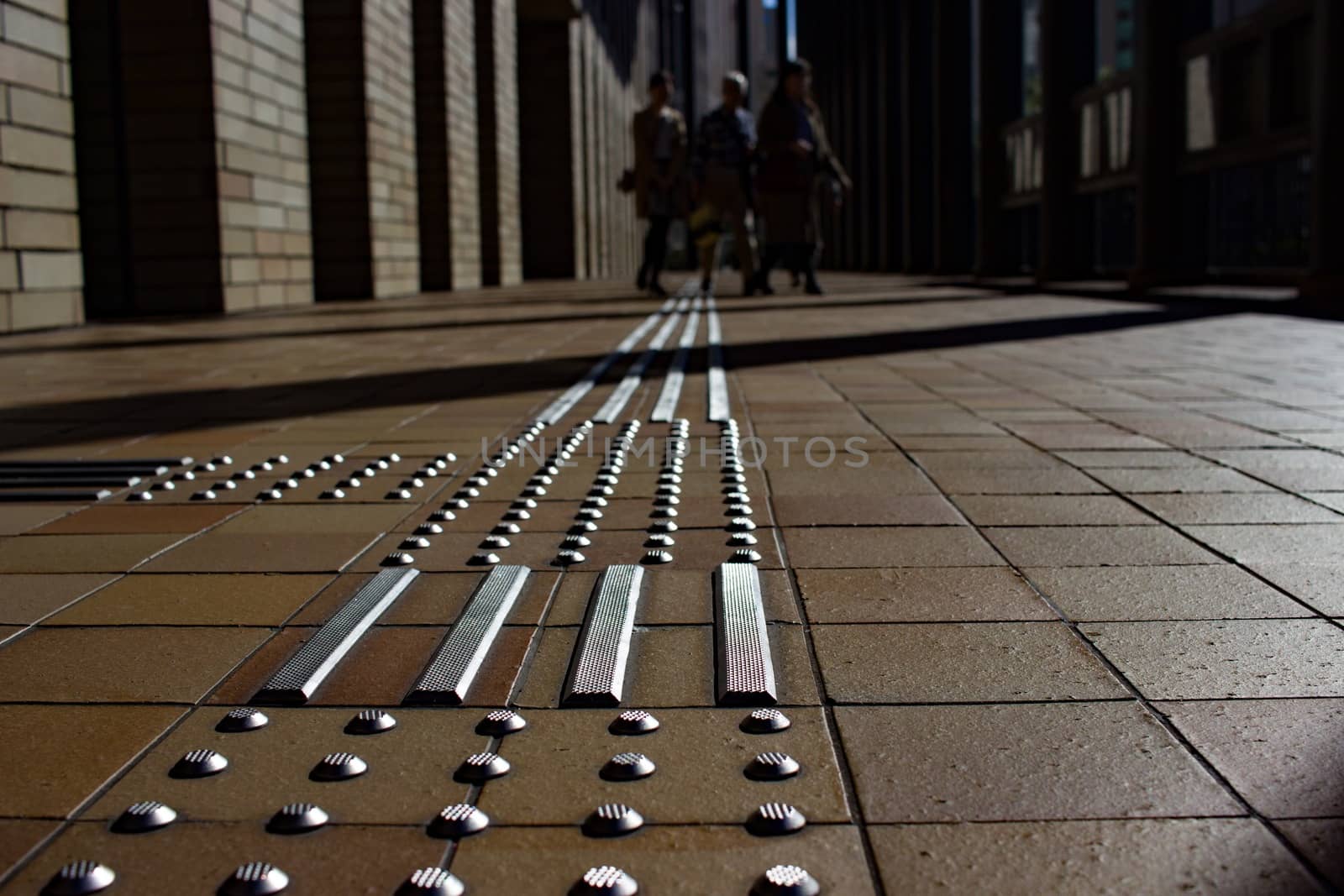 Tactile paving outside a large building in Osaka.
