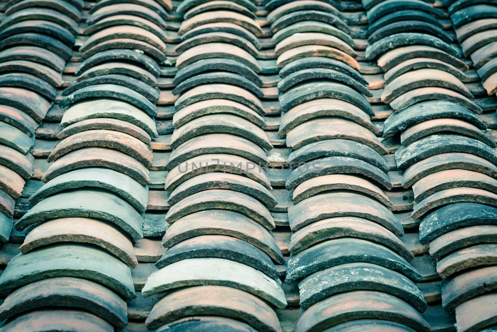 Filtered image colorful curved clay tiled roof from ancient house in the North Vietnam by trongnguyen