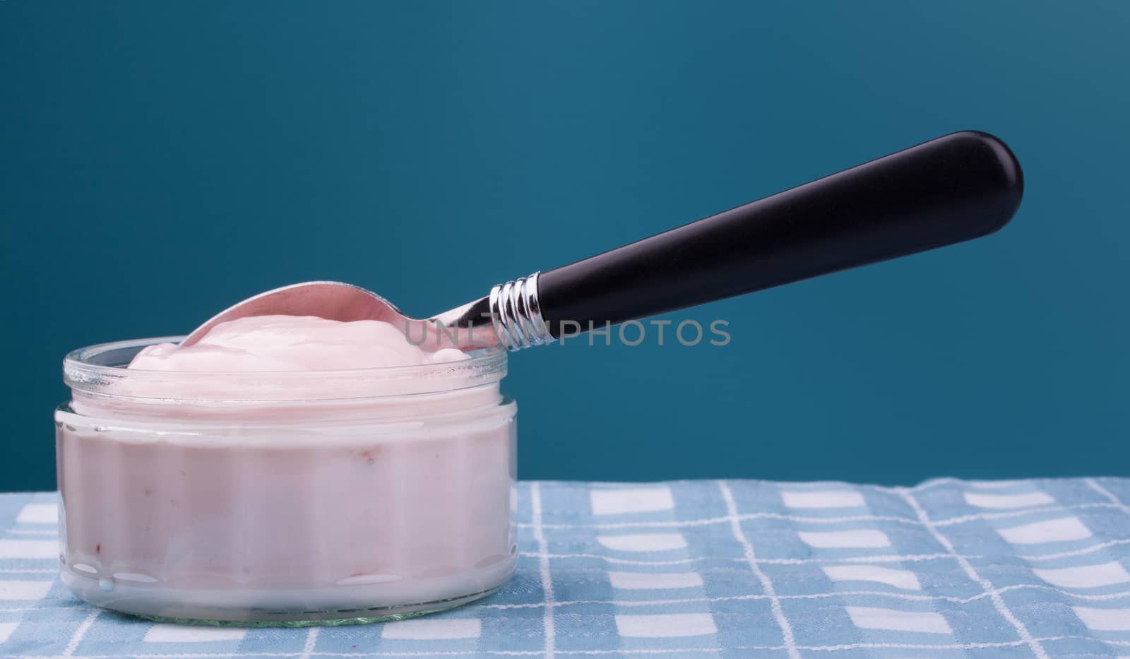 Pink strawberry yogurt in a clear glass bowl