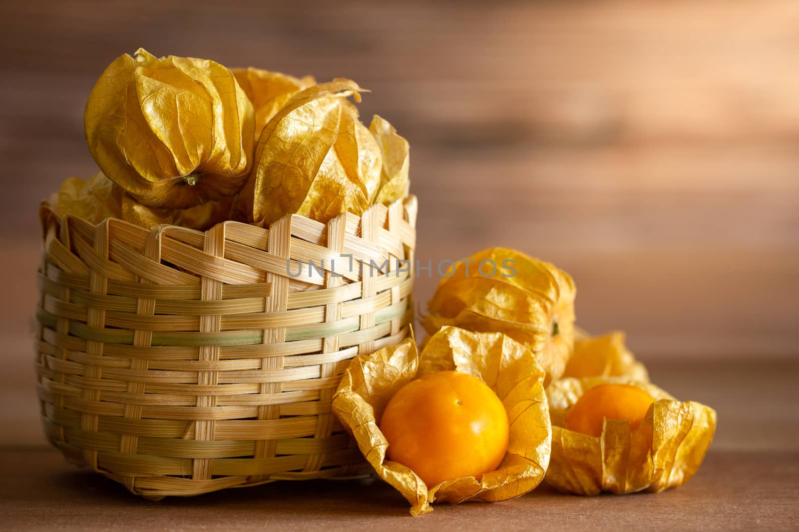 Cape gooseberry in bamboo basket. Concept of health care or herb. Closeup and copy space for text.