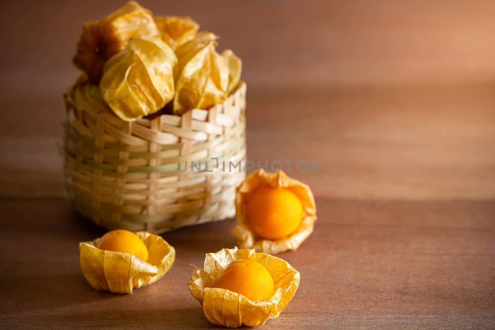 Cape gooseberry in bamboo basket. Concept of health care or herb. Closeup and copy space for text.