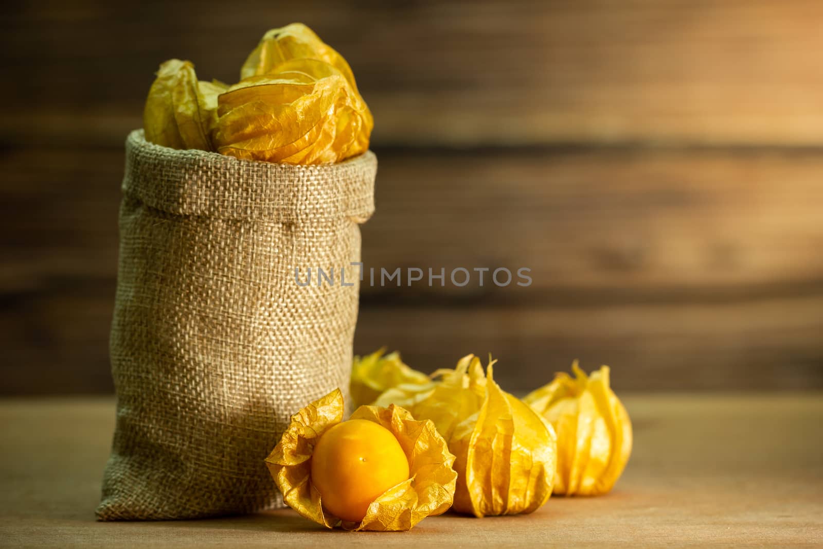 Cape gooseberry in burlap bags. Concept of health care or herb. Closeup and copy space for text.