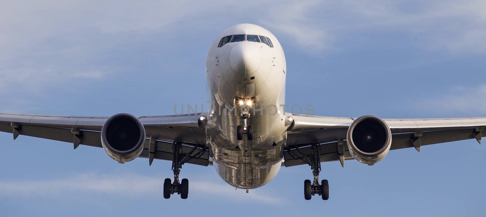 Front view of a passenger jet coming in to land at Osaka International Airport, Itami.