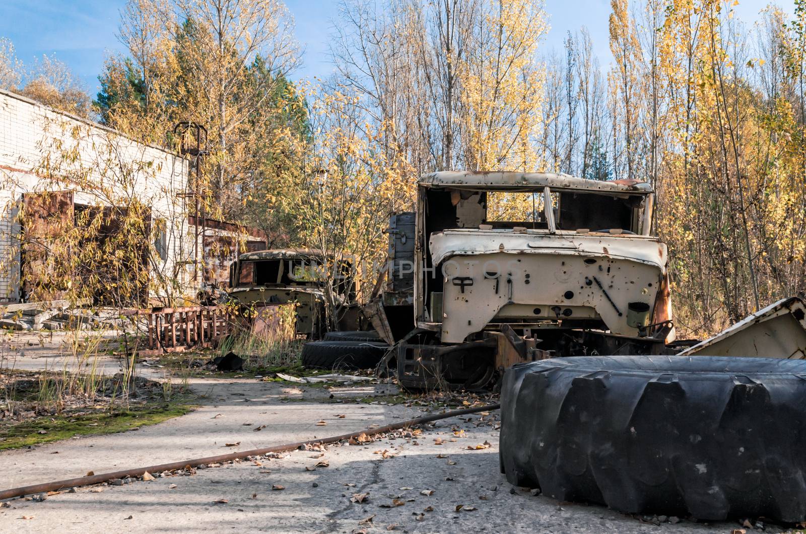 abandoned broken equipment car among trees in Chernobyl Ukraine in autumn