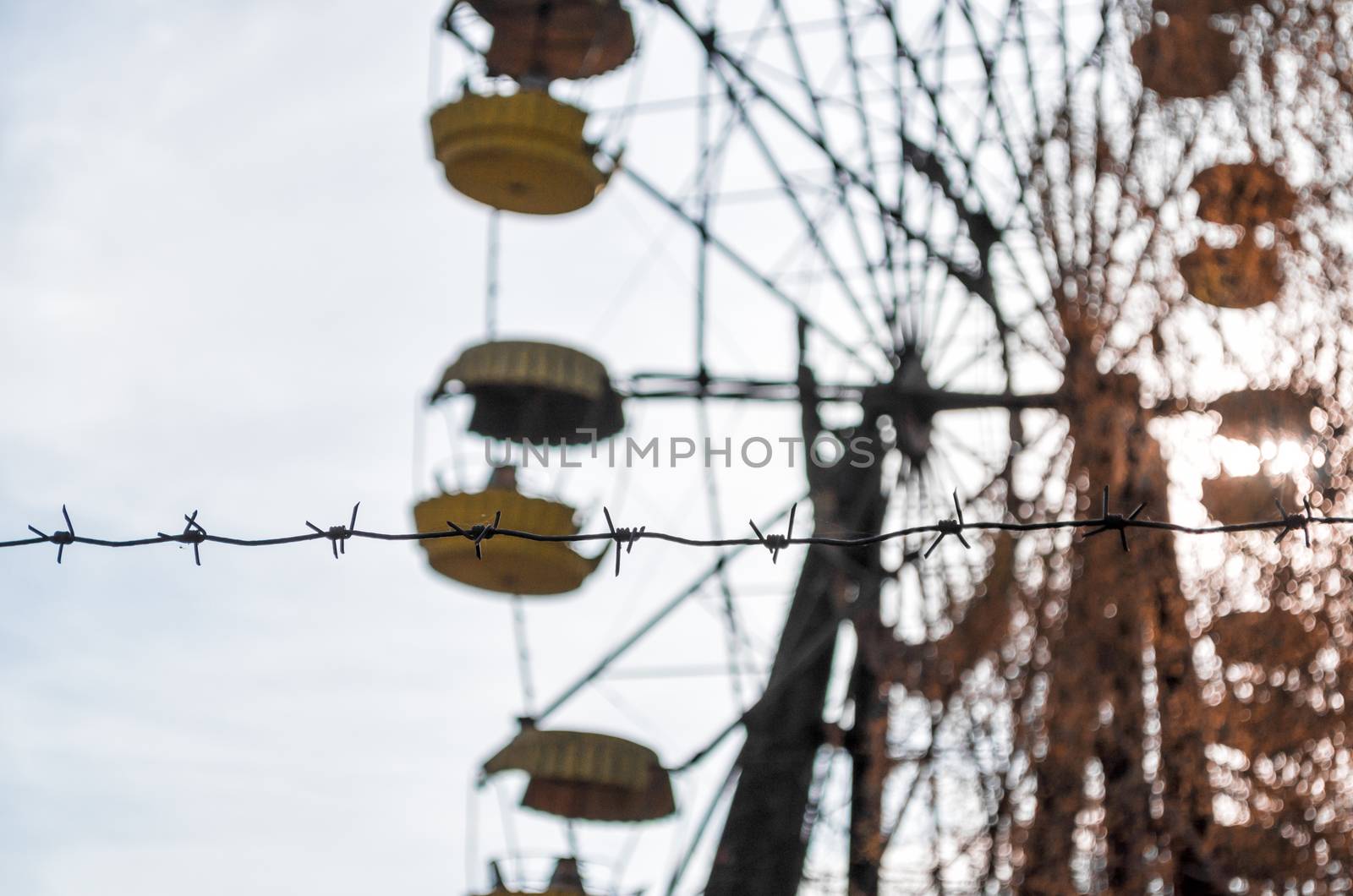 barbed wire and cabins old carousel wheel in an abandoned amusement park in Chernobyl Ukraine in autumn