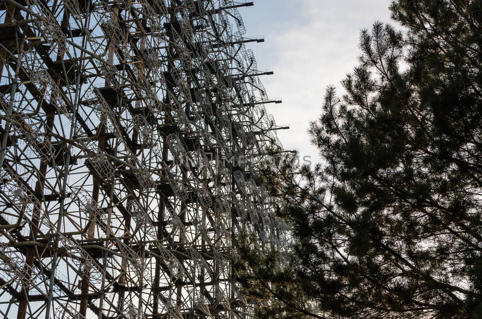 secret army soviet radar and pine tree on a background of blue sky and clouds in Chernobyl Ukraine