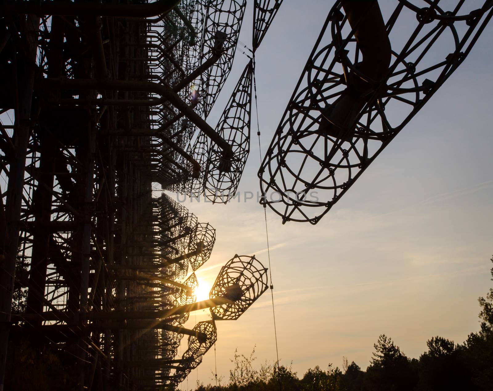 secret army antenna radar in the forest at sunset with sun rays in Chernobyl Ukraine in autumn