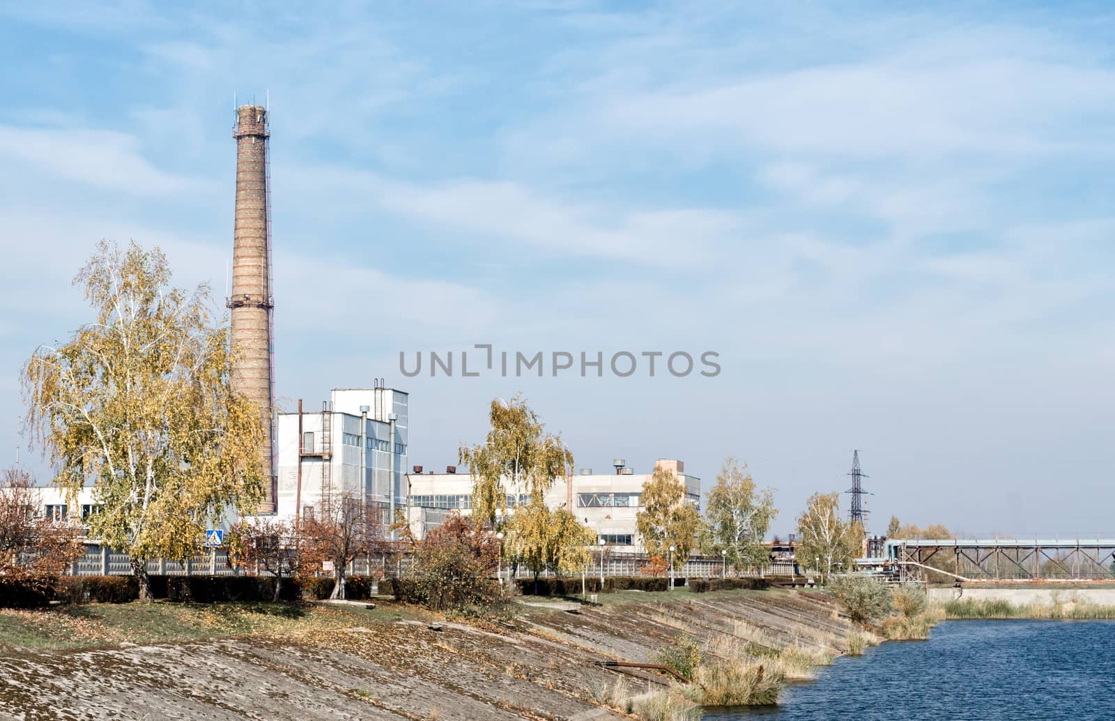 famous place nuclear power plant on the river bank against the blue sky in Chernobyl Ukraine in the afternoon in the fall