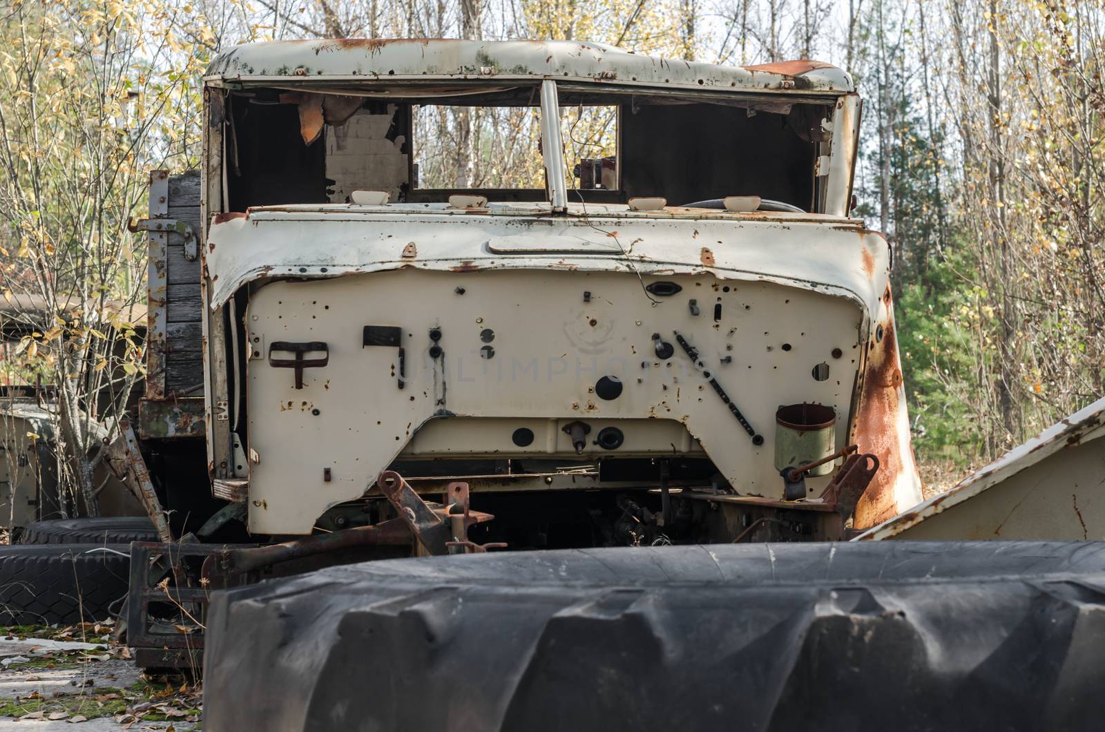 abandoned broken equipment car in the Chernobyl forest Ukraine in autumn