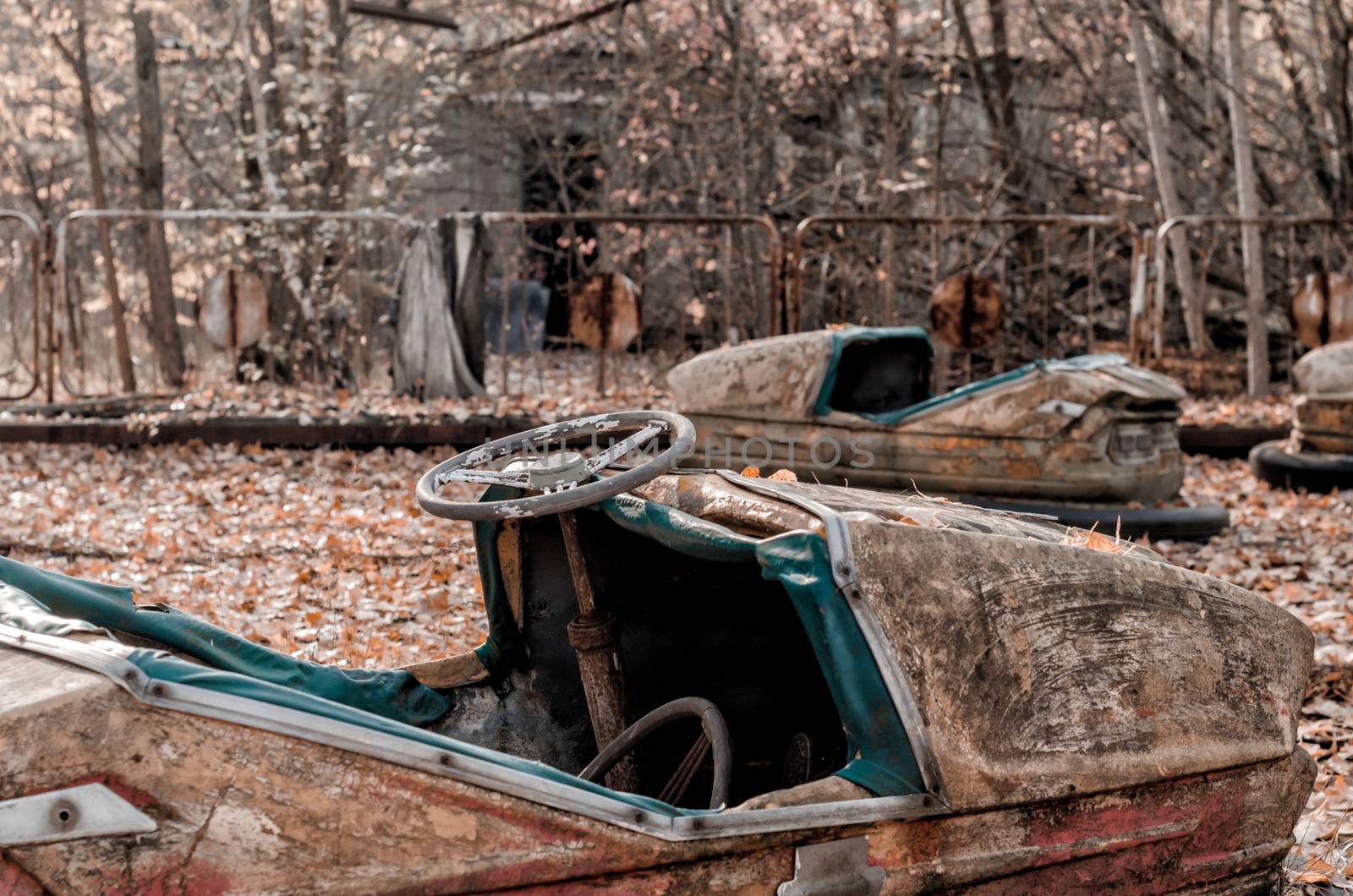 cars and nobody in an abandoned amusement park closeup in Chernobyl Ukraine
