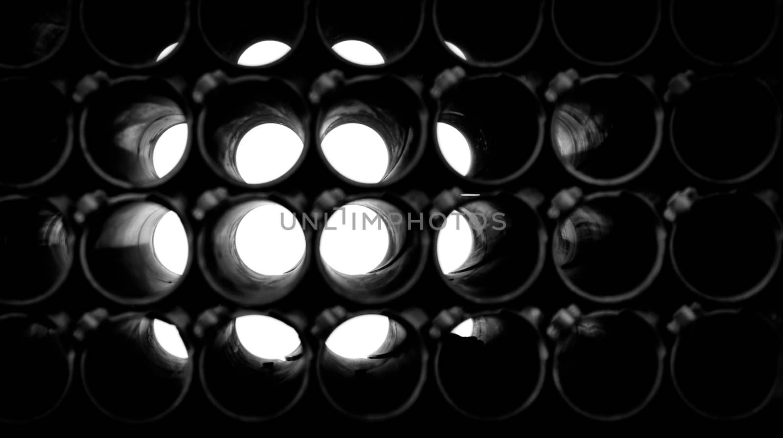 abstract dark black and white background of round pipes