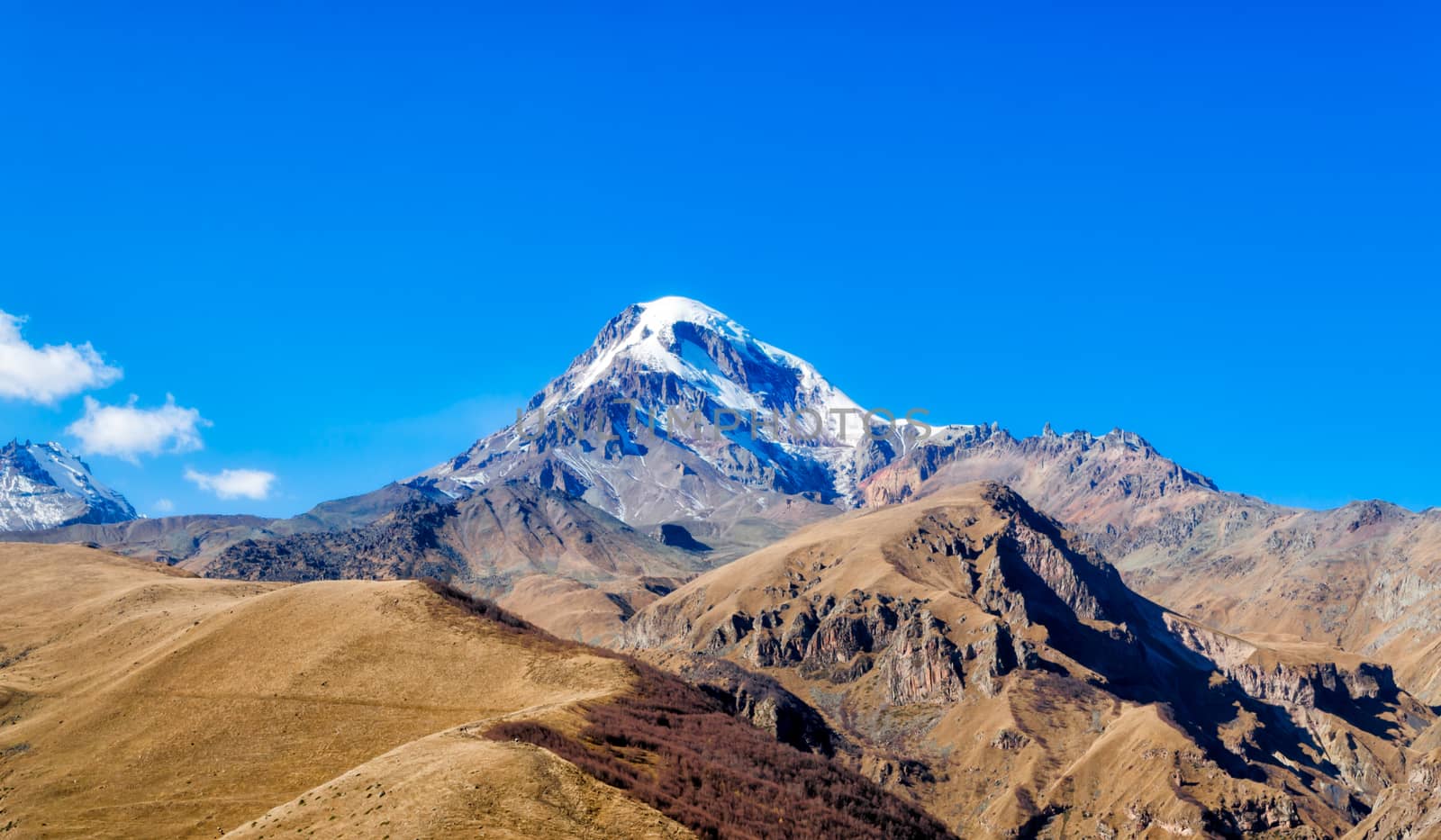 landscape high rocky mountains of the Caucasus in Georgia on a background of blue sky and clouds