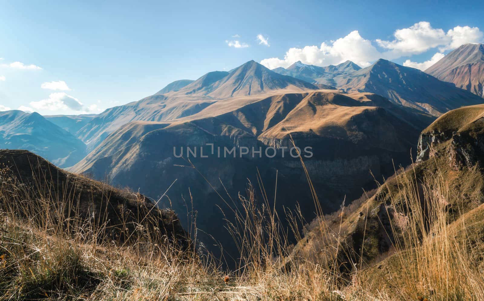 mountain landscape with blue sky and clouds in Georgia in autumn
