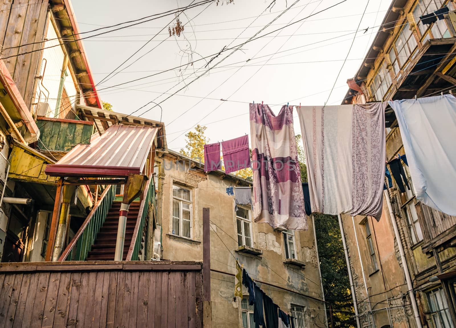 old houses with stairs and balconies with ropes and clothes in Tbilisi Georgia