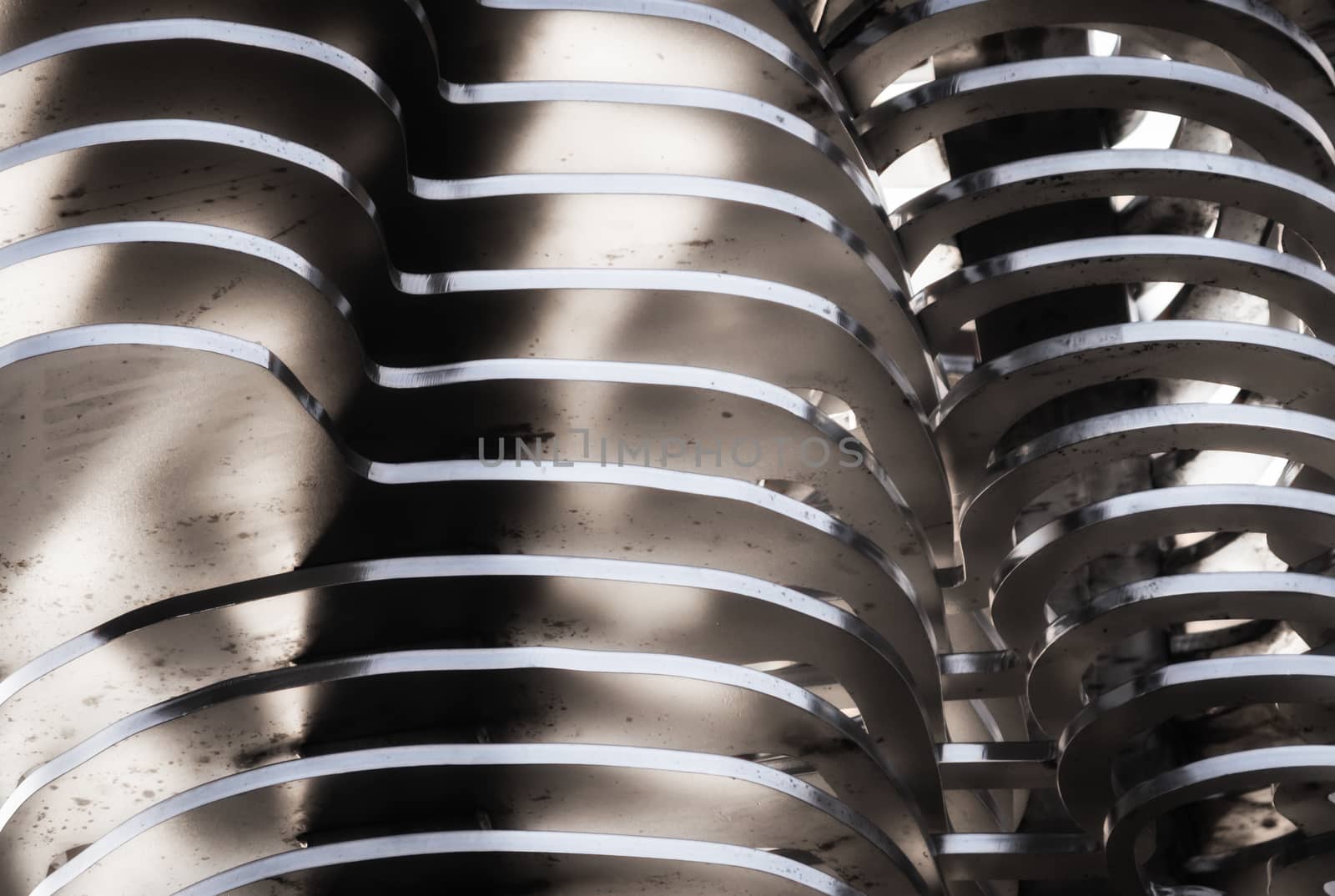 abstract background smooth curved lines metal construction close up