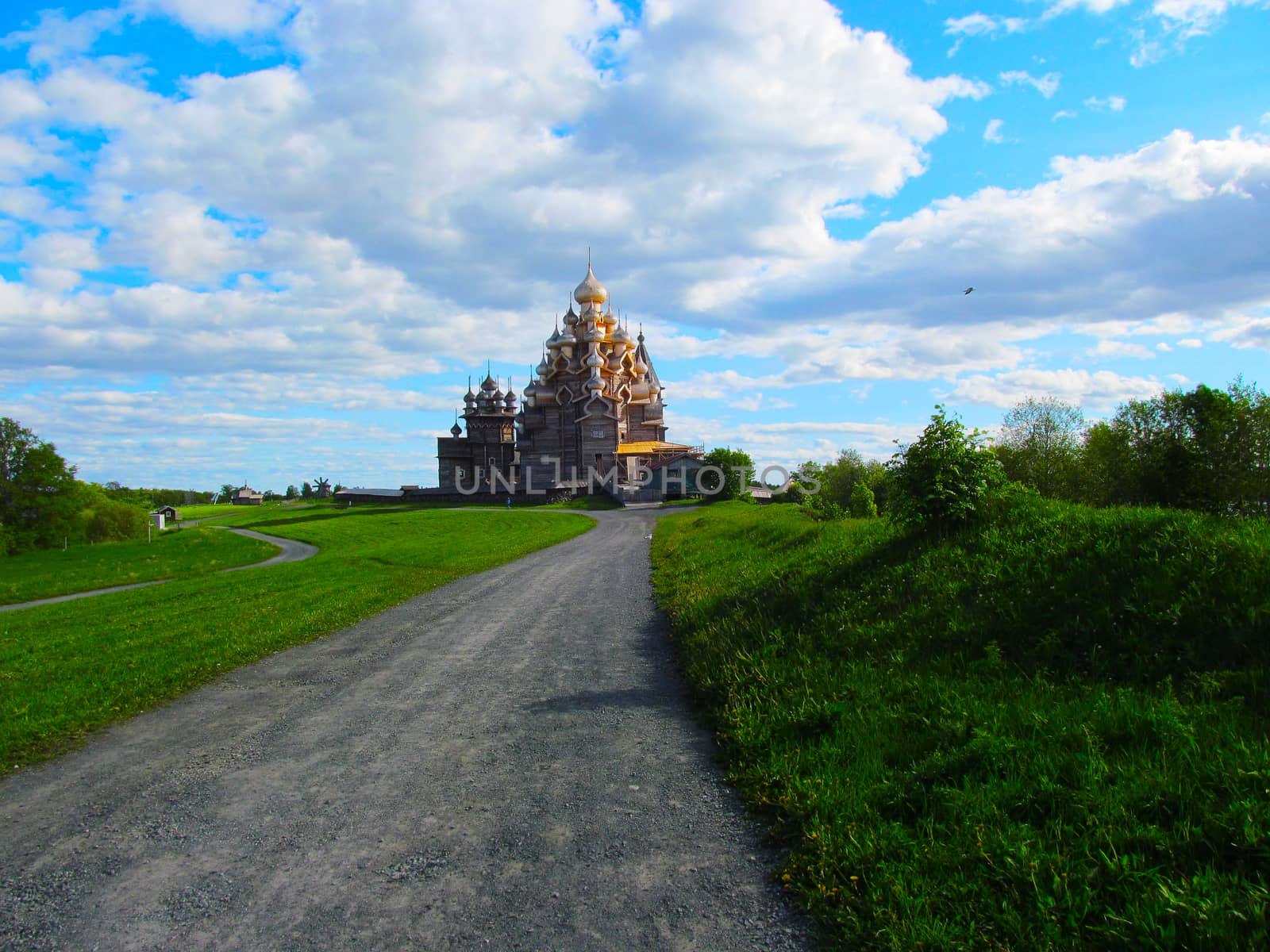 Church on a background of blue sky road and green fields. by Igor2006