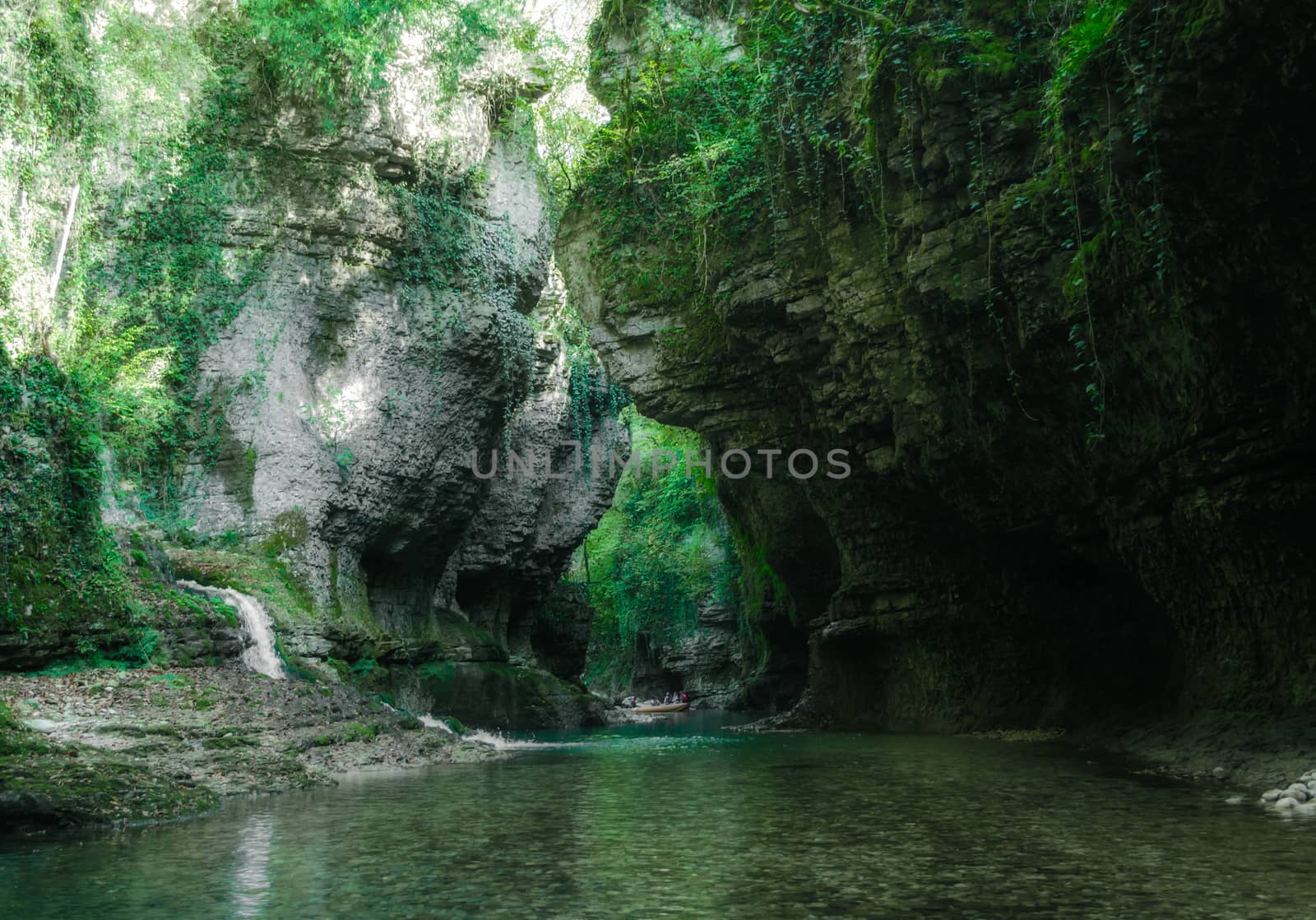 mountain river and stream among high stone cliffs with green plants in Martville Canyon in Georgia in autumn