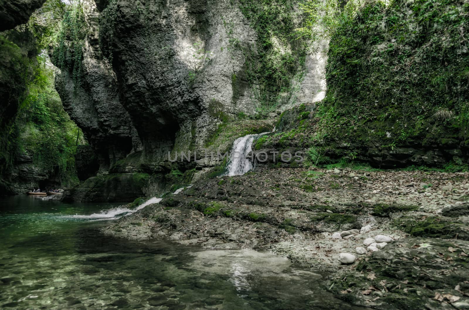 mountain river and stream among high stone cliffs with green plants in Martville Canyon in Georgia in autumn