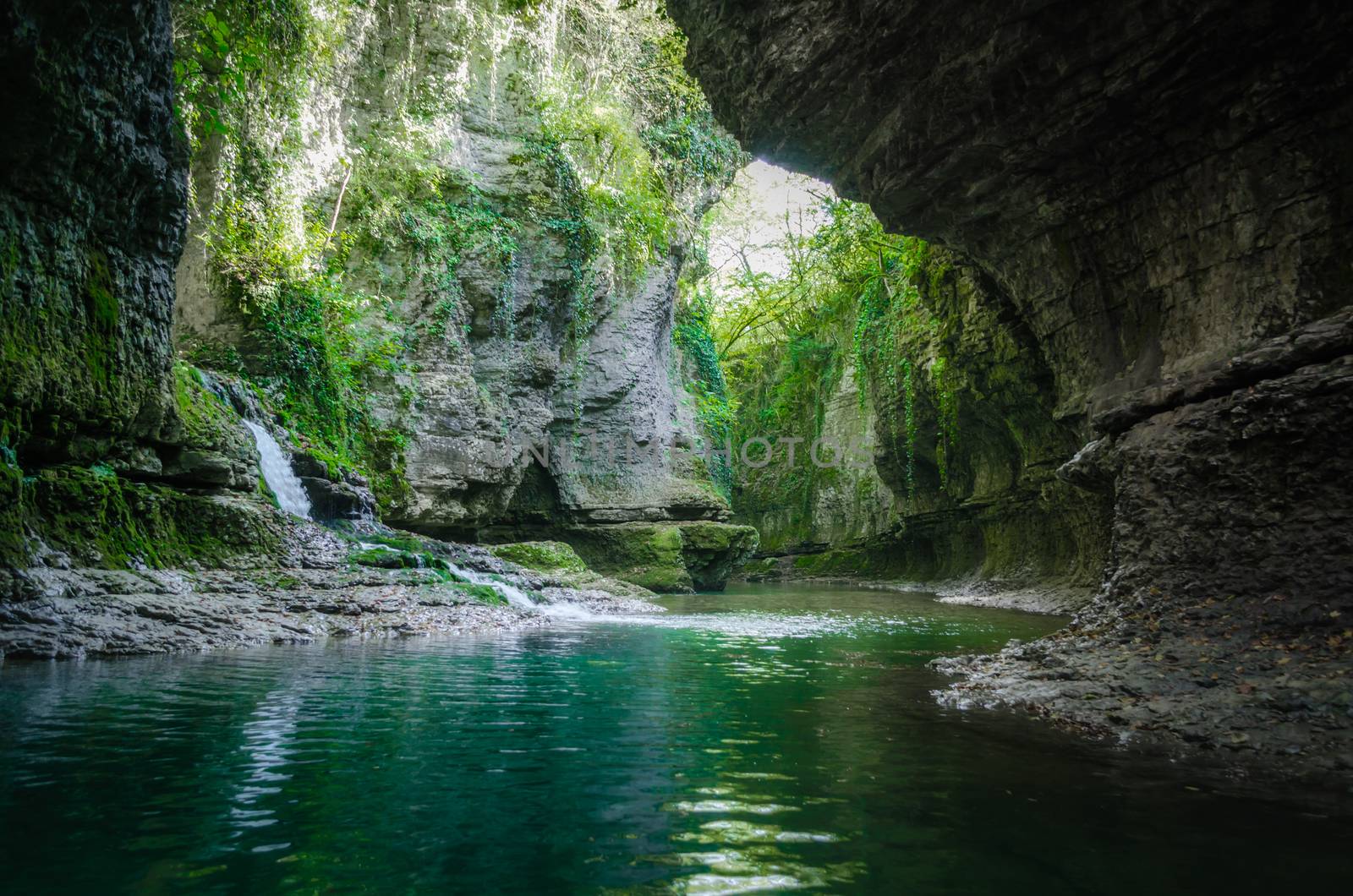 mountain river and stream among high stone cliffs with green plants in Martville Canyon in Georgia in autumn