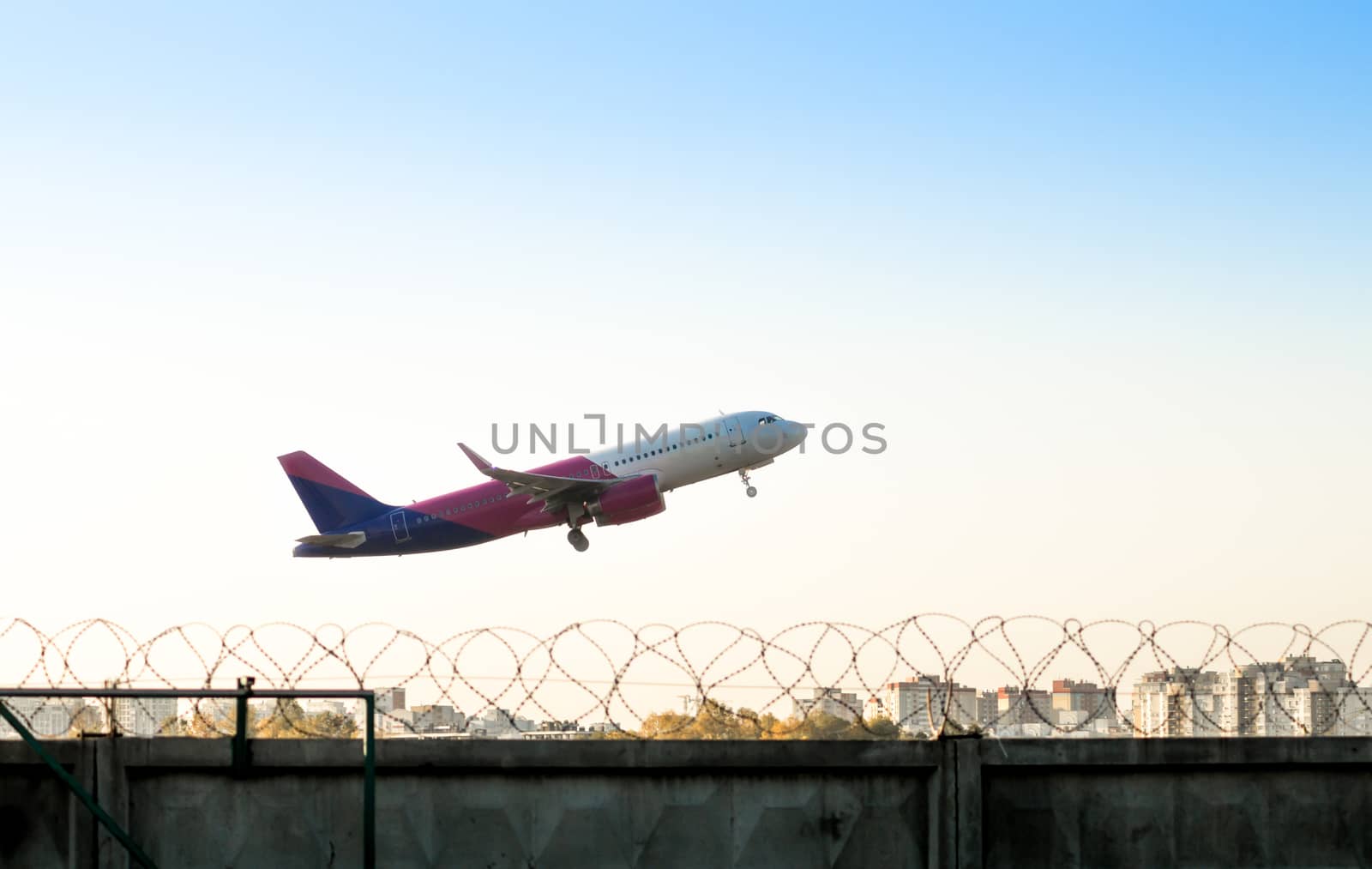 take off airliner over the city with a fence of barbed wire at the airport of Kiev Ukraine