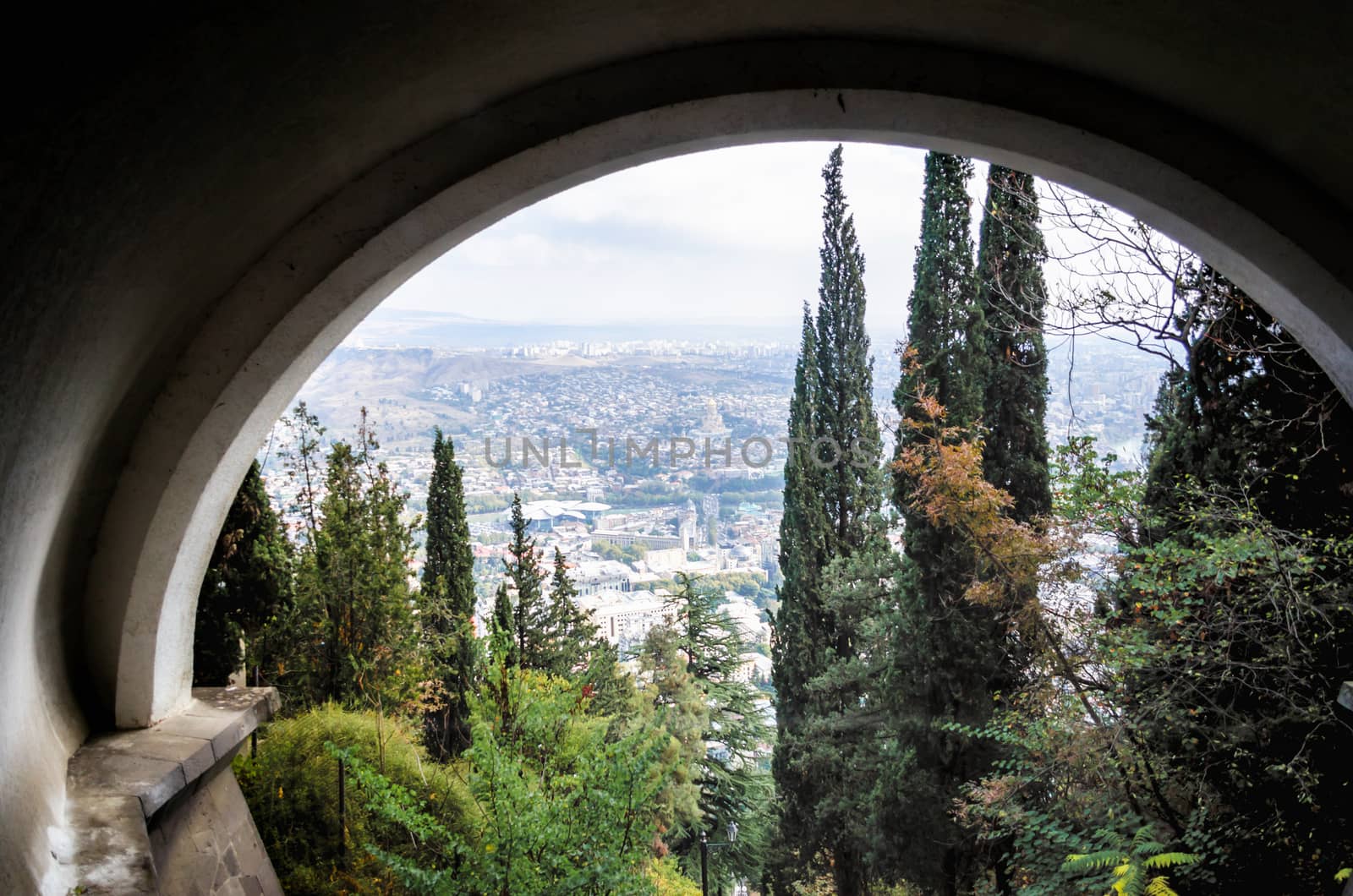 landscape panorama of Tbilisi city among trees in Georgia in autumn