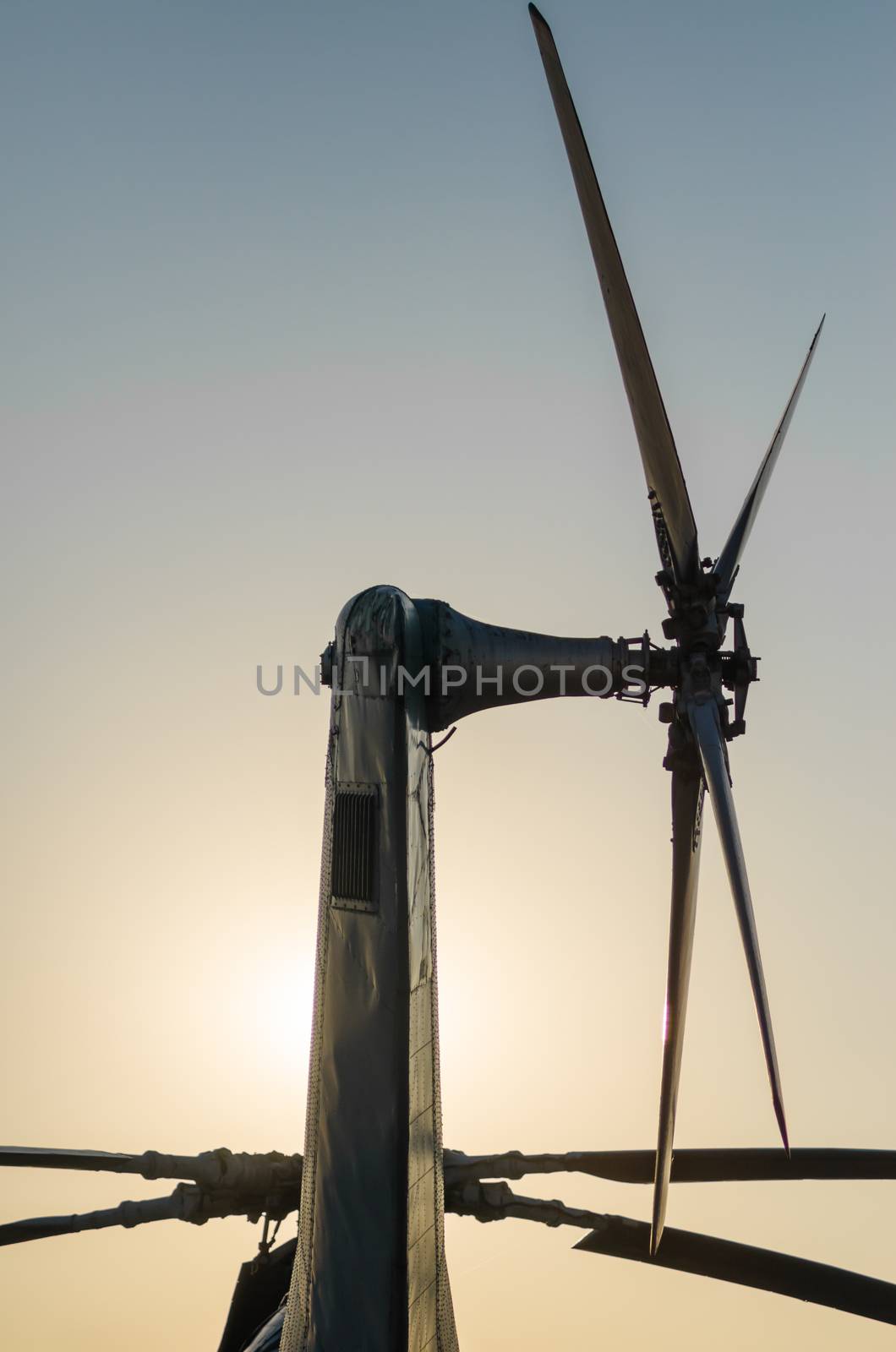 transport rotor blade background of an old vintage helicopter isolated on a background of the evening sky and sun