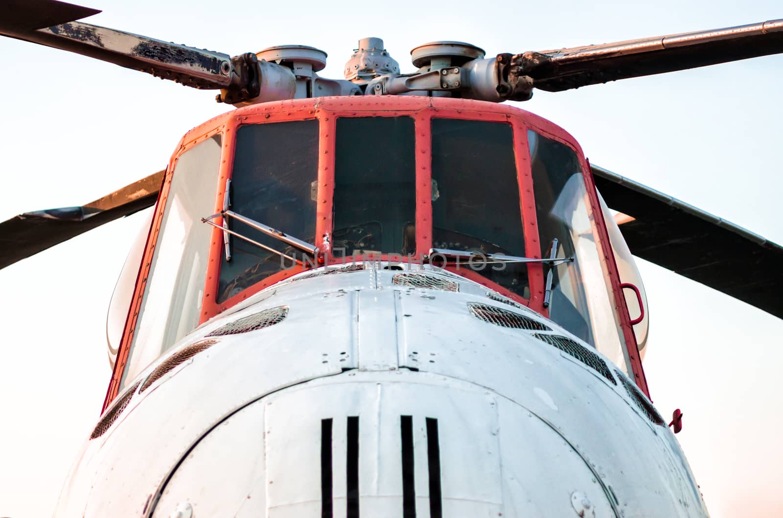 cockpit of an old vintage helicopter with blades isolated close up