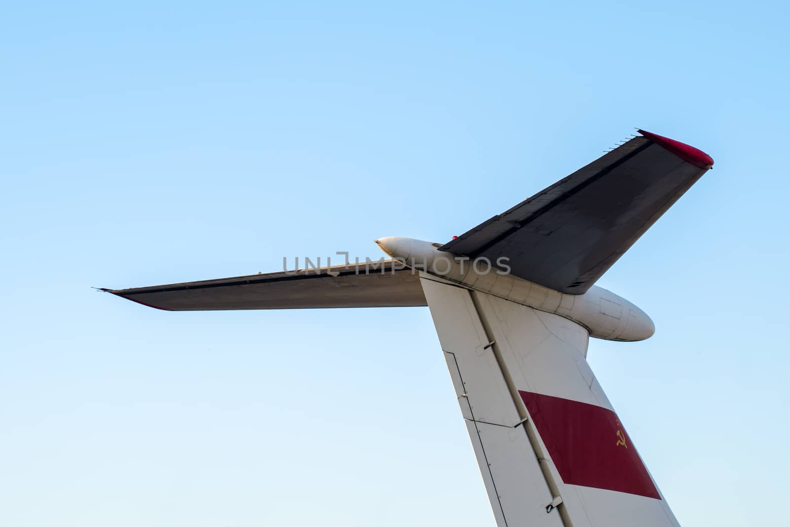 part tail of a soviet airliner close up isolated on a blue sky background