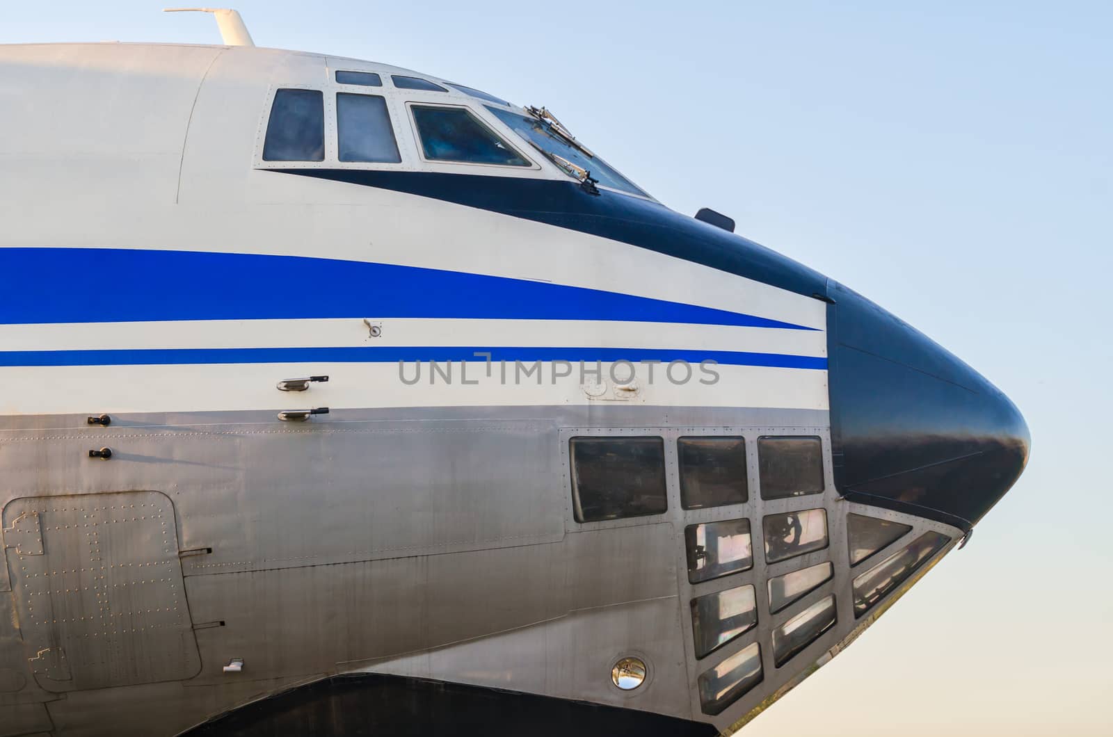 cockpit of a large vintage civilian plane with blue stripes isolated closeup
