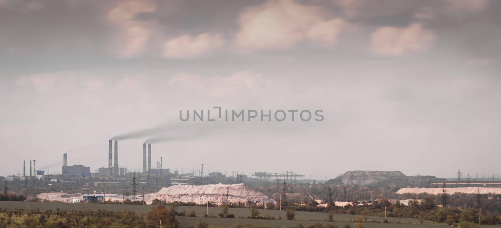 panorama view of the factory with smoking chimneys and the sky with clouds in Ukraine