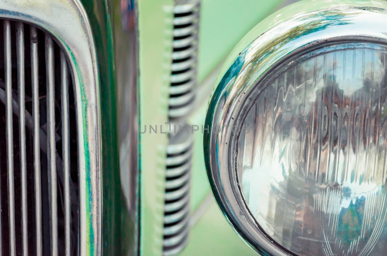 headlight and radiator of an old retro car closeup