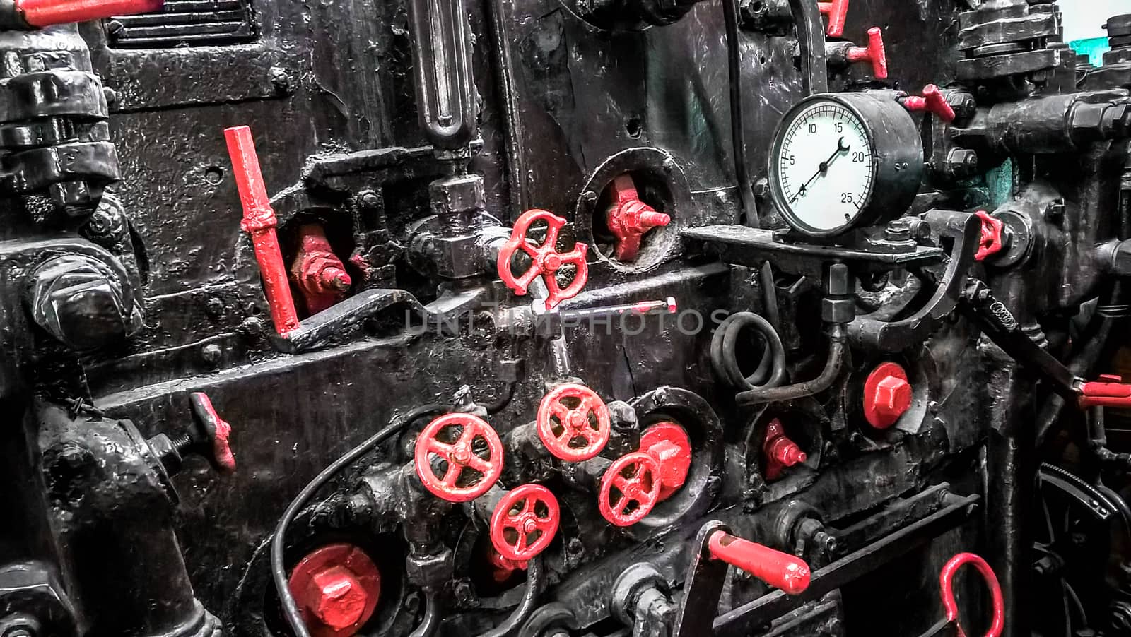 controls and valves in the cabin of an old steam locomotive