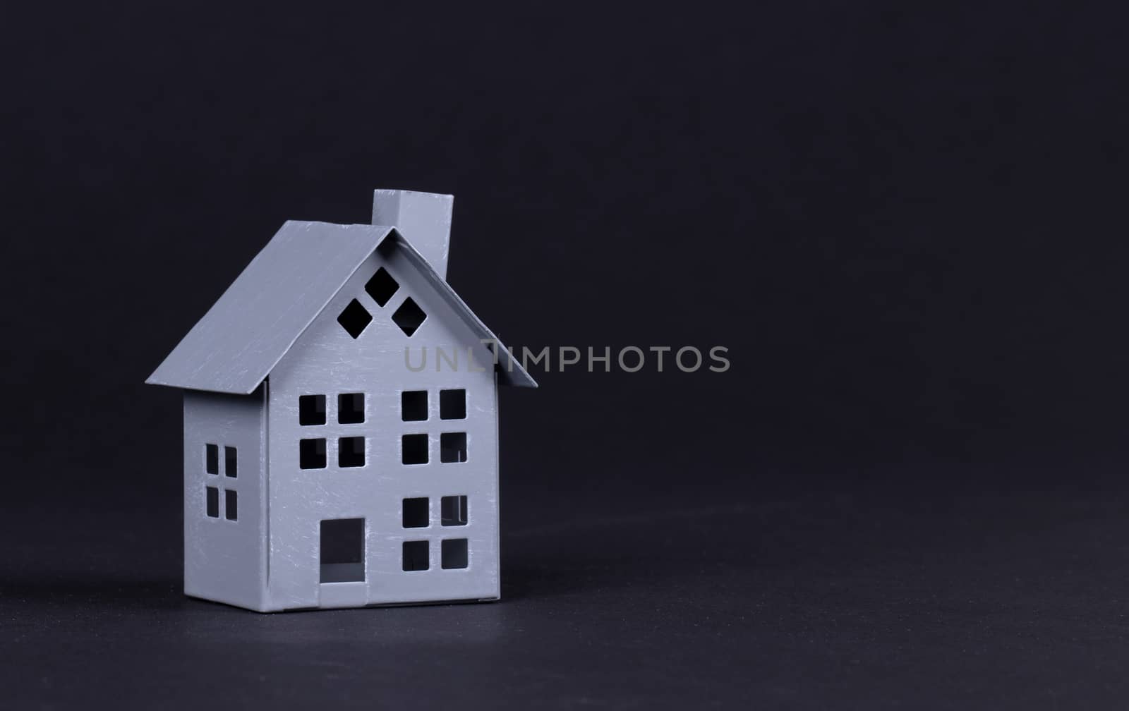 Estate concept, metal house on isolated on black background - Idea for real estate concept, personal property and family house