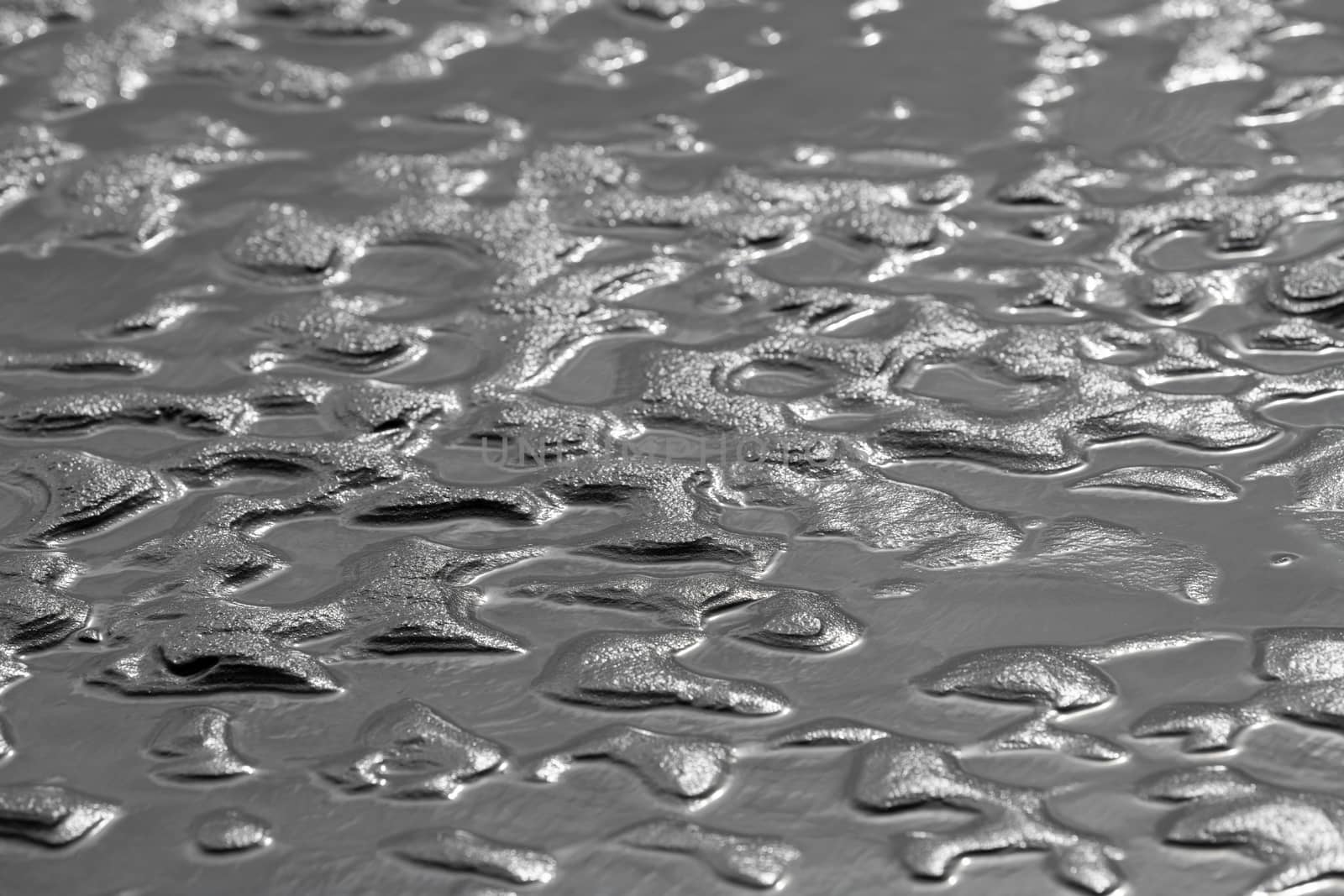 Abstract sand and water structures in the North Sea beach of the island Terschelling 
