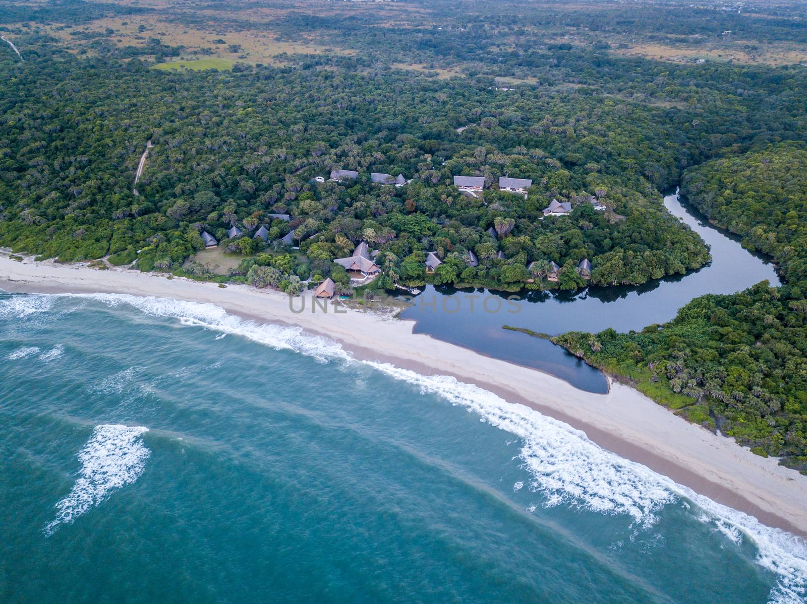 Drone picture of a hotel by a lagoon in a coastal forest on the Swahili Coast, Tanzania.