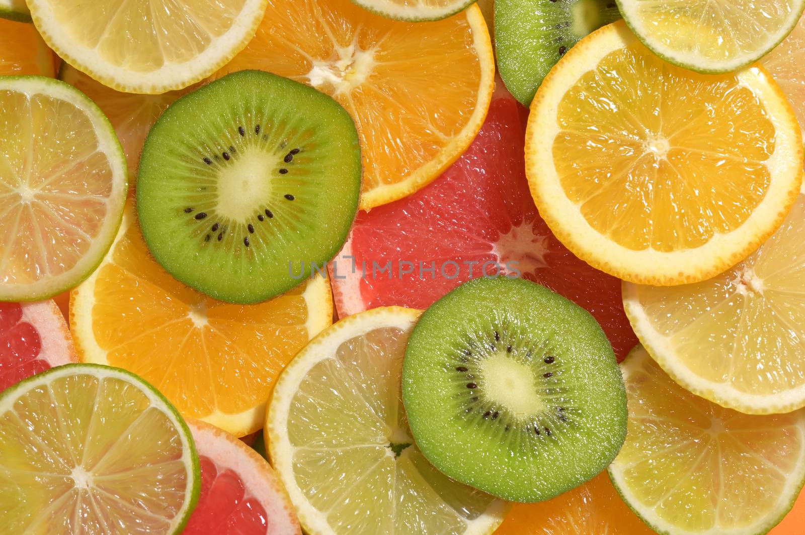 Fruit Slices Background With Lemon, Lime, Kiwi, Orange by jordachelr