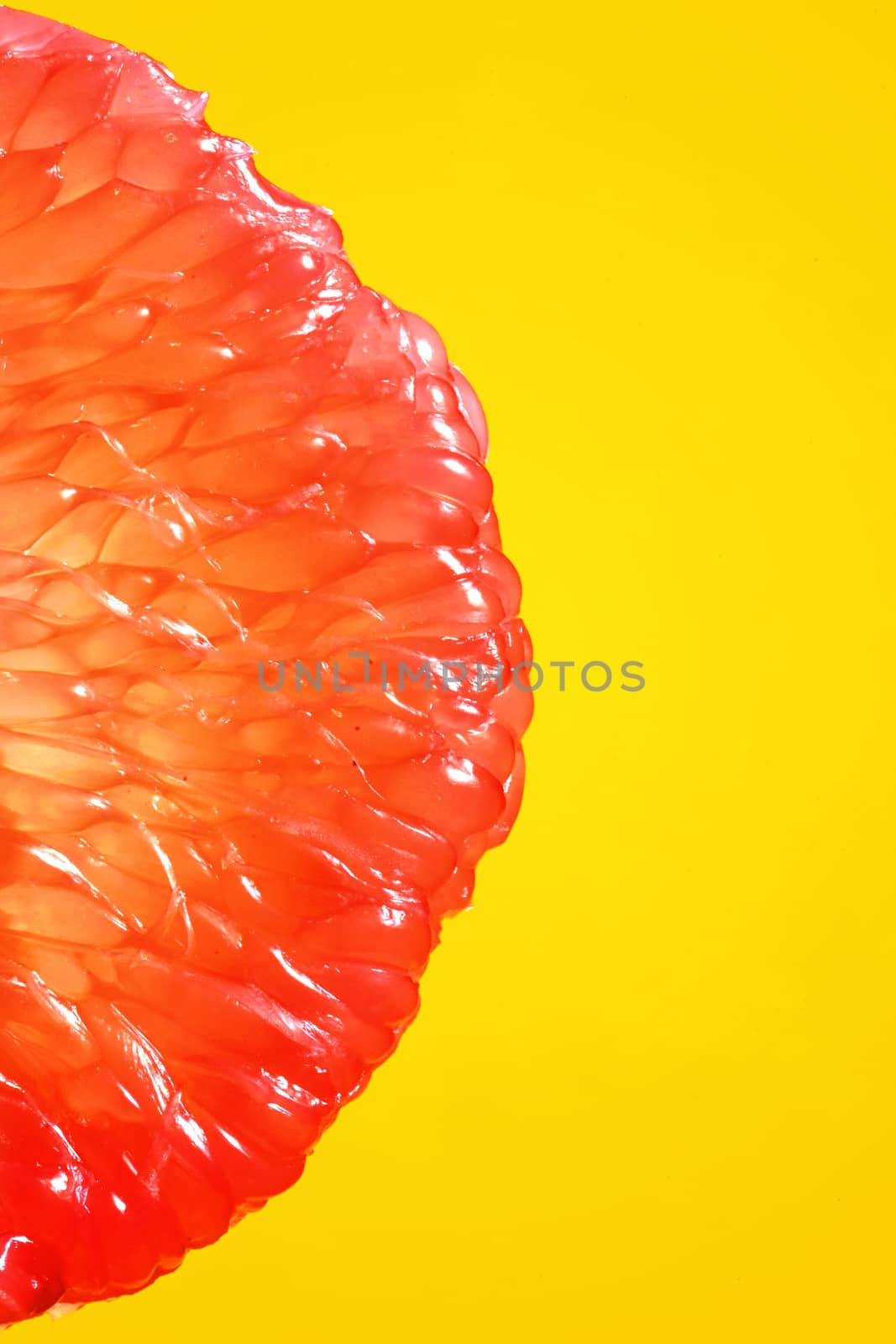 Peeled Slice Of Juicy Grapefruit on Yellow Background
