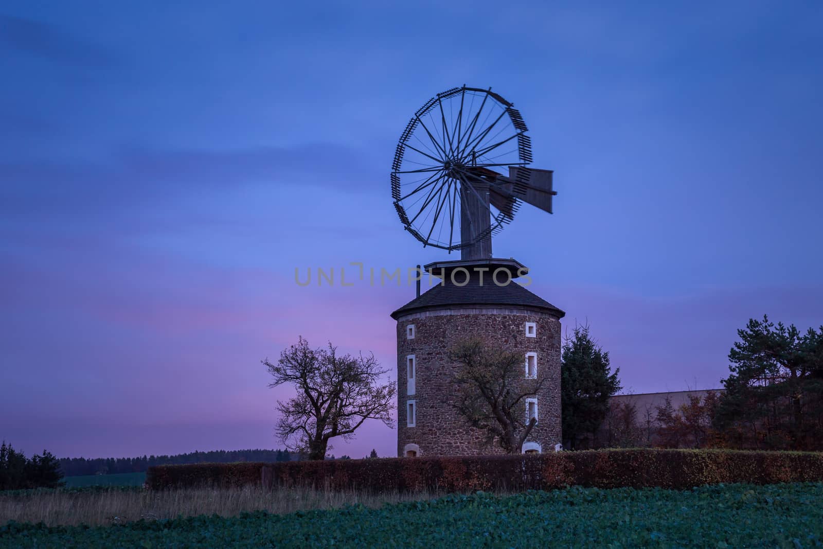 Spooky landscape with haunted wind mill at night. Moment after sunset. Windmill called Ruprechtov in Czech republic. by petrsvoboda91