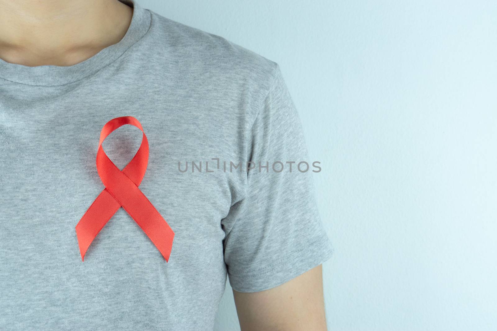 Aids awareness, red ribbon on the man chest. World Aids Day, Hea by mikesaran