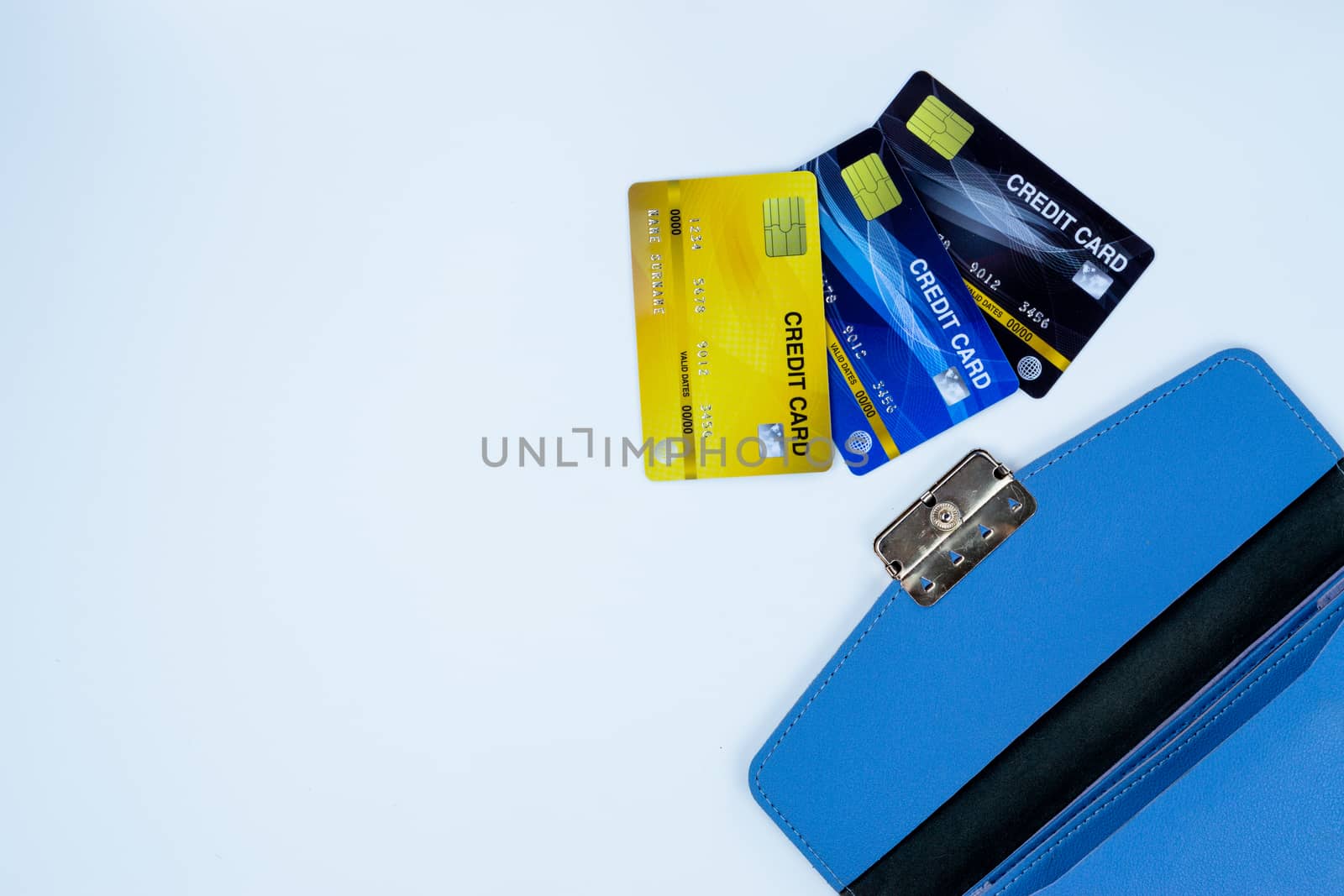 Credit card with blue woman purse for payment on the white background. Finance and money concept, top view, copy space for text.