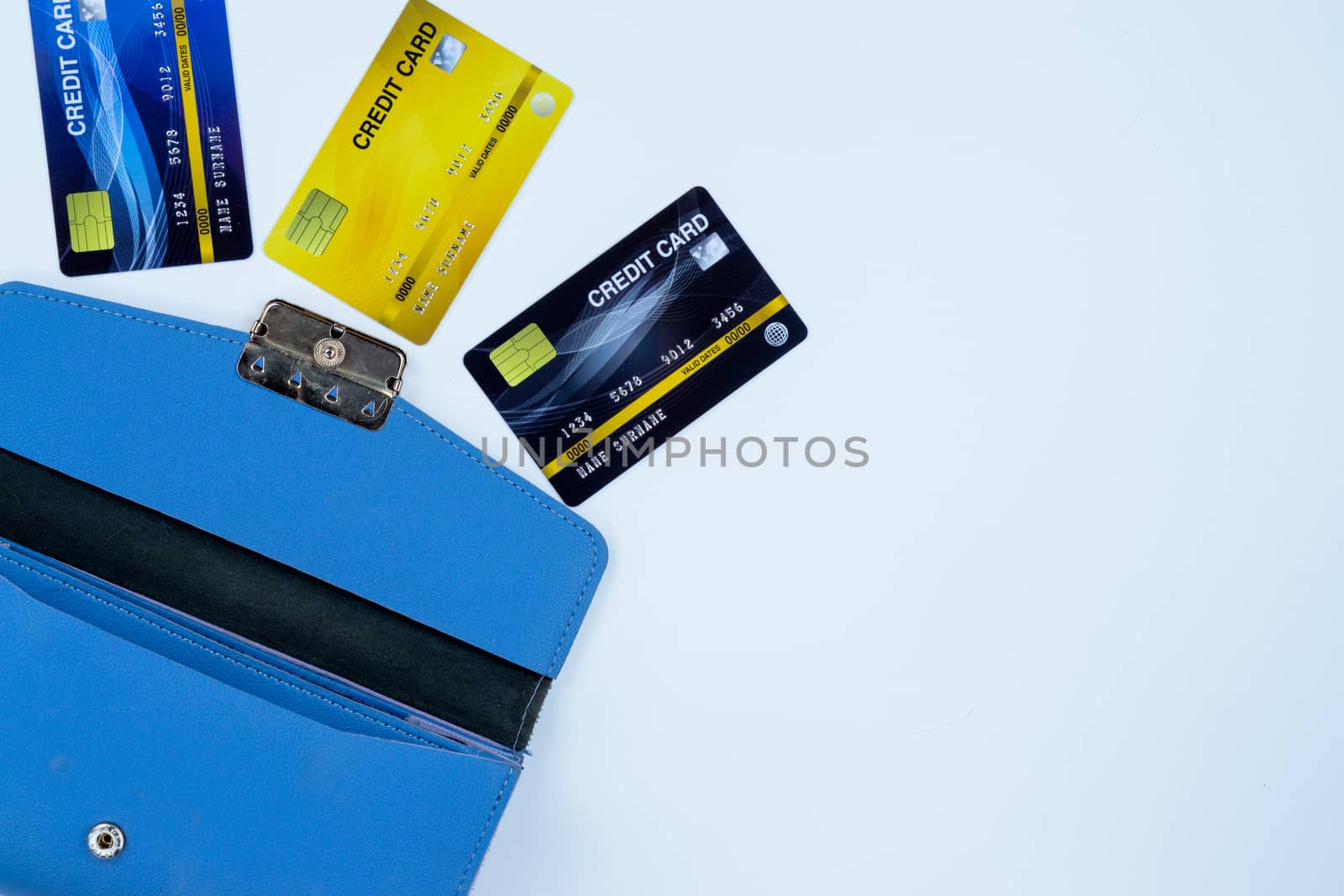 Credit card with blue woman purse for payment on the white background. Finance and money concept, top view, copy space for text.