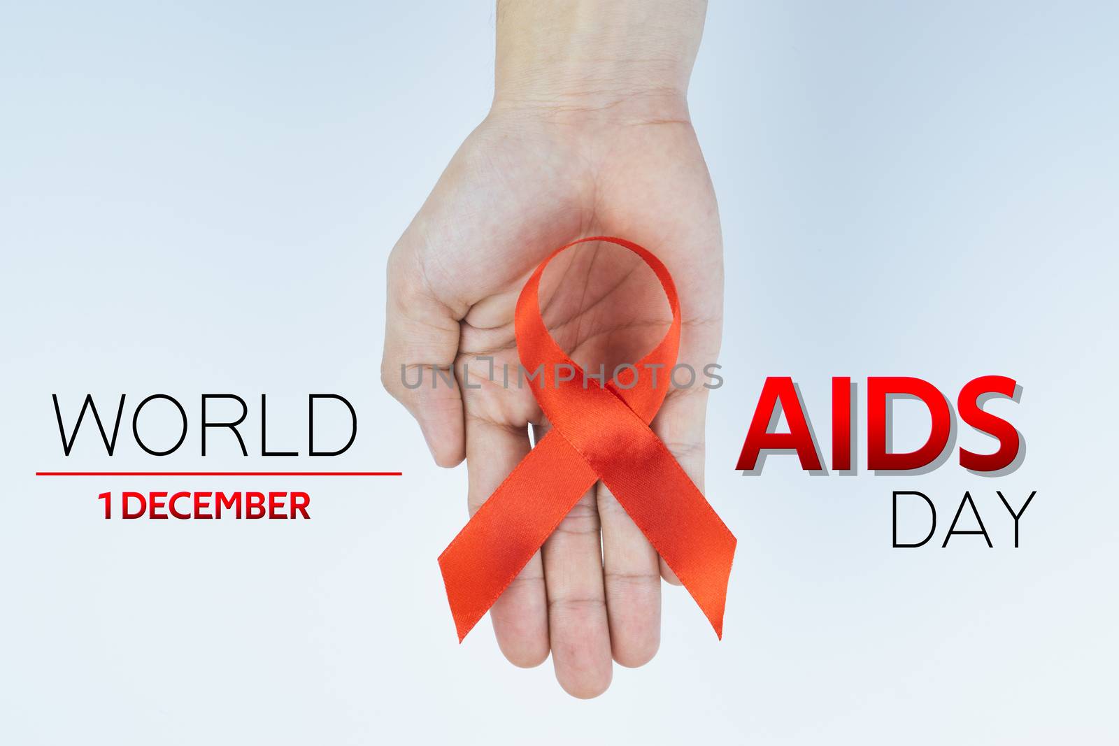 Aids awareness, male hands holding red AIDS awareness ribbon on  by mikesaran