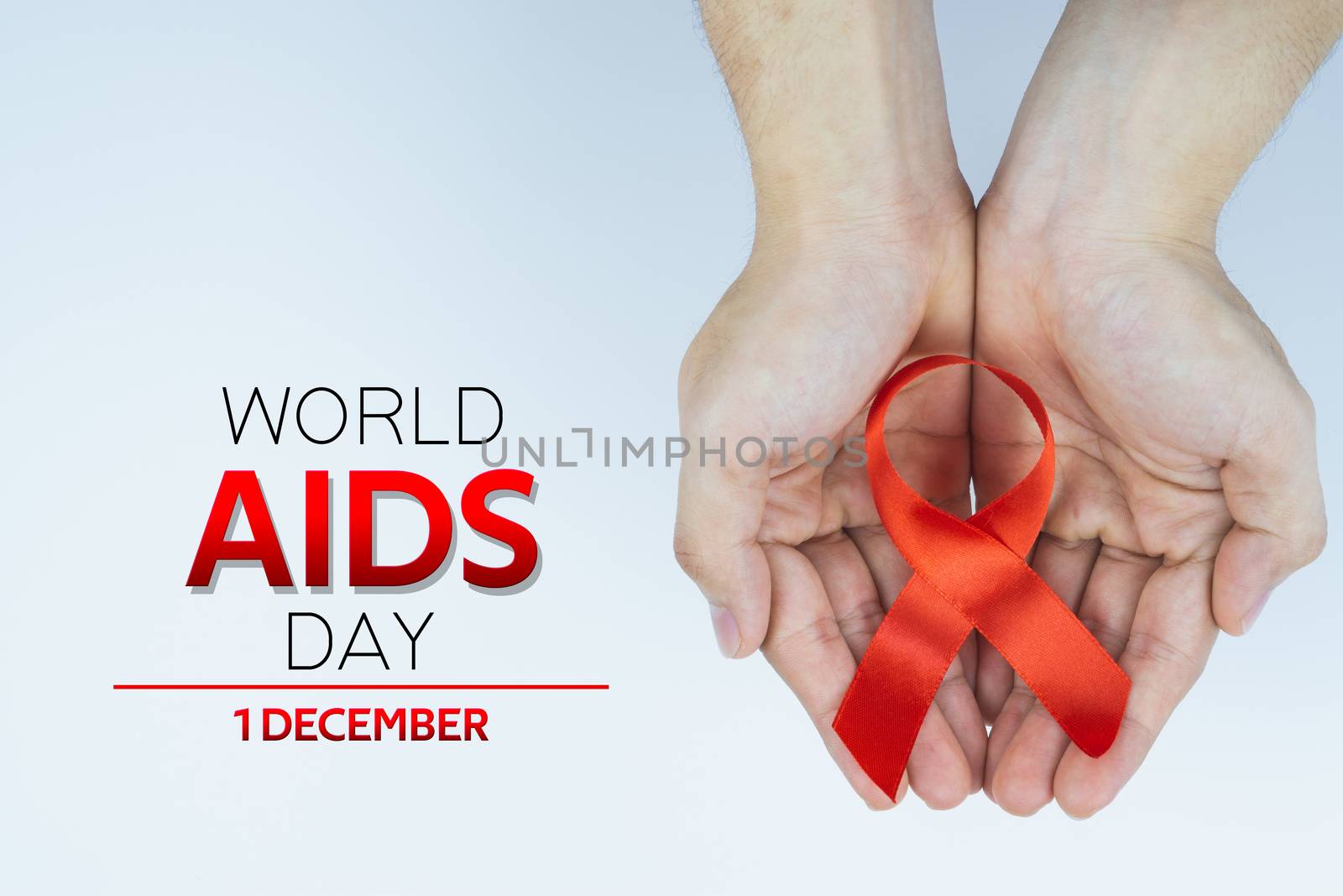 Aids awareness, male hands holding red AIDS awareness ribbon on white background. World Aids Day, Healthcare and medical concept.