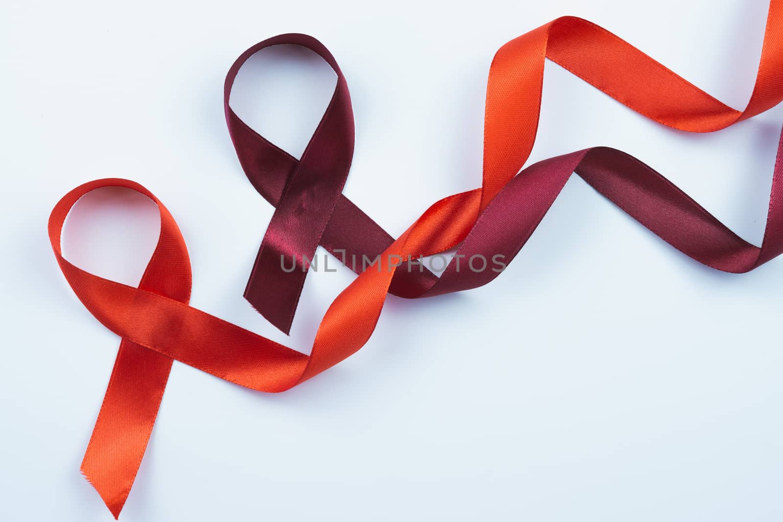 Aids awareness, red ribbon on white background with copy space f by mikesaran