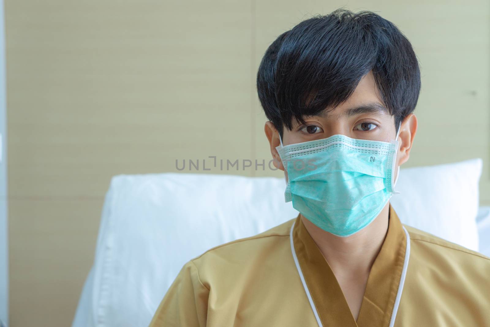 A patient man wearing face mask to prevent illness spread out at hospital. Sick and health concept.