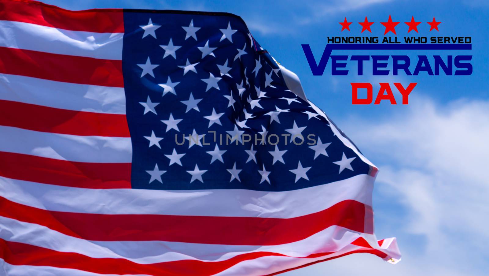 Happy Veterans Day with American flags on blue sky background.