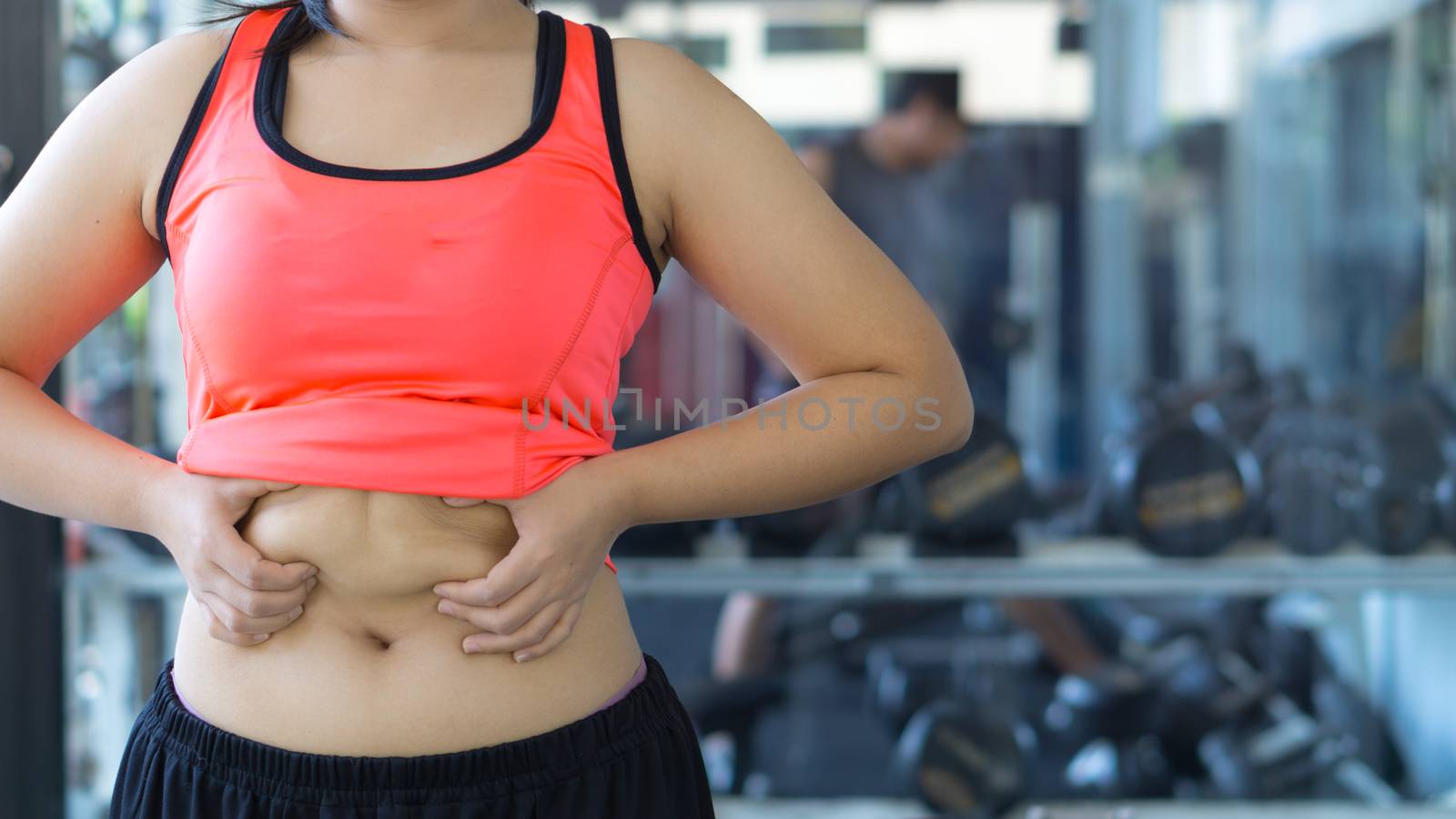 Close up woman holding excessive fat belly. Woman overweight abdomen. Woman diet lifestyle concept reduce belly and shape up healthy stomach muscle. Weight loss, slim body, healthy lifestyle concept.